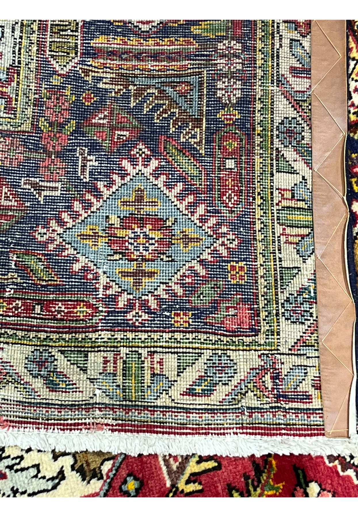 Backside of the Tabriz showing fine even hand-knotting, clear pattern, and cotton foundation