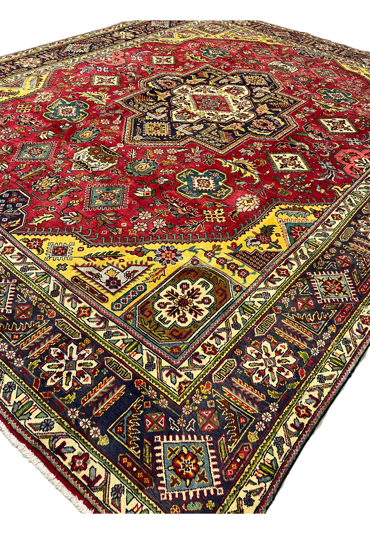 Angled view of the 10'6" x 13'4" Tabriz highlighting plush wool pile and golden medallion corner spandrels