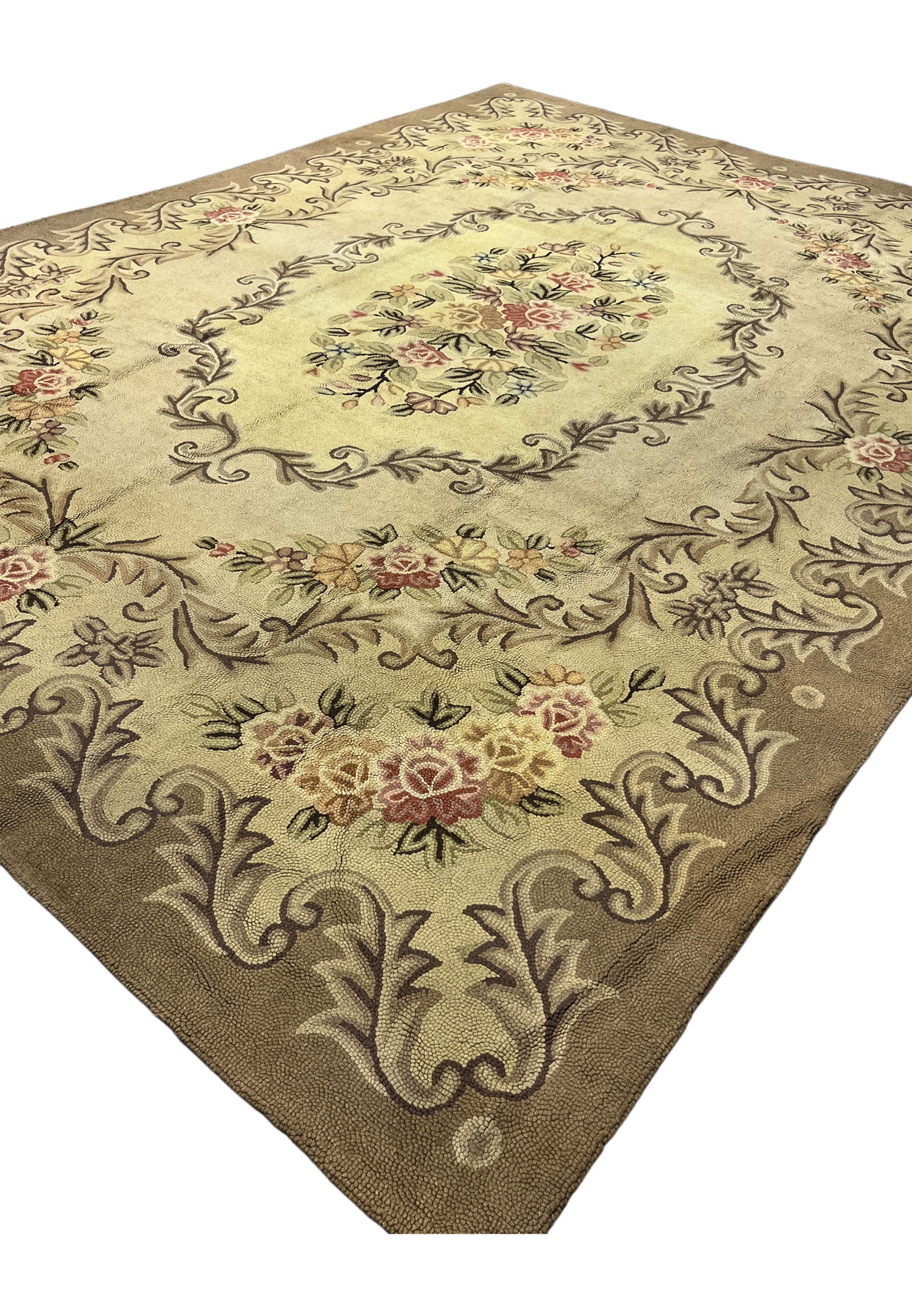 Angled view of the 8' x 11'4" hooked rug showing the cream Aubusson field and soft floral border
