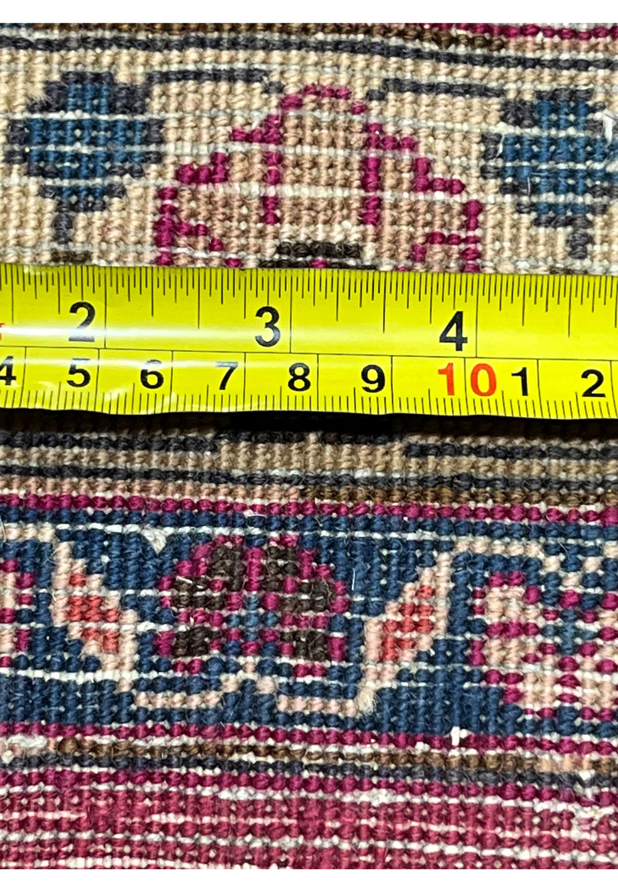 Tape measure on the back of the Mashad documenting its fine hand-knotted wool density