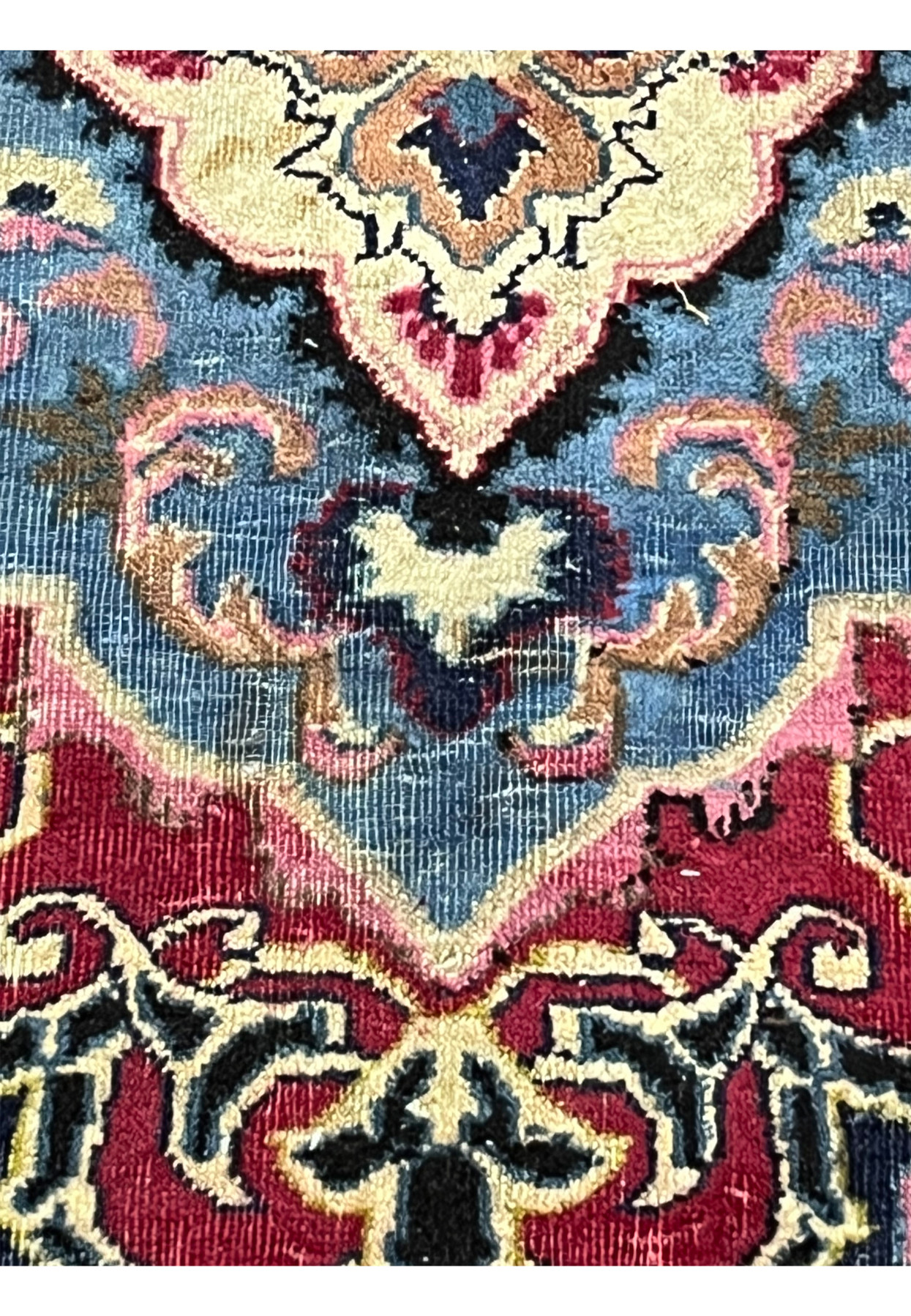 Pile detail of the Kashmar showing the soft blue medallion and aged wool surface