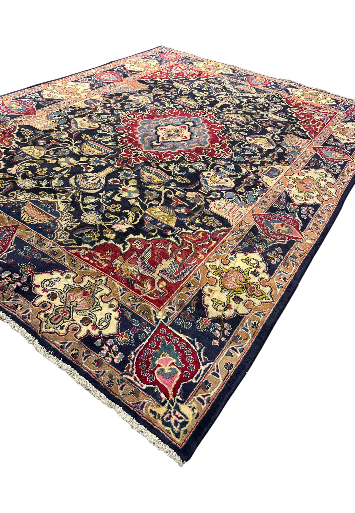 Angled view of the 8x11 Kashmar Zirkhaki rug showing the navy archaeology field and red border