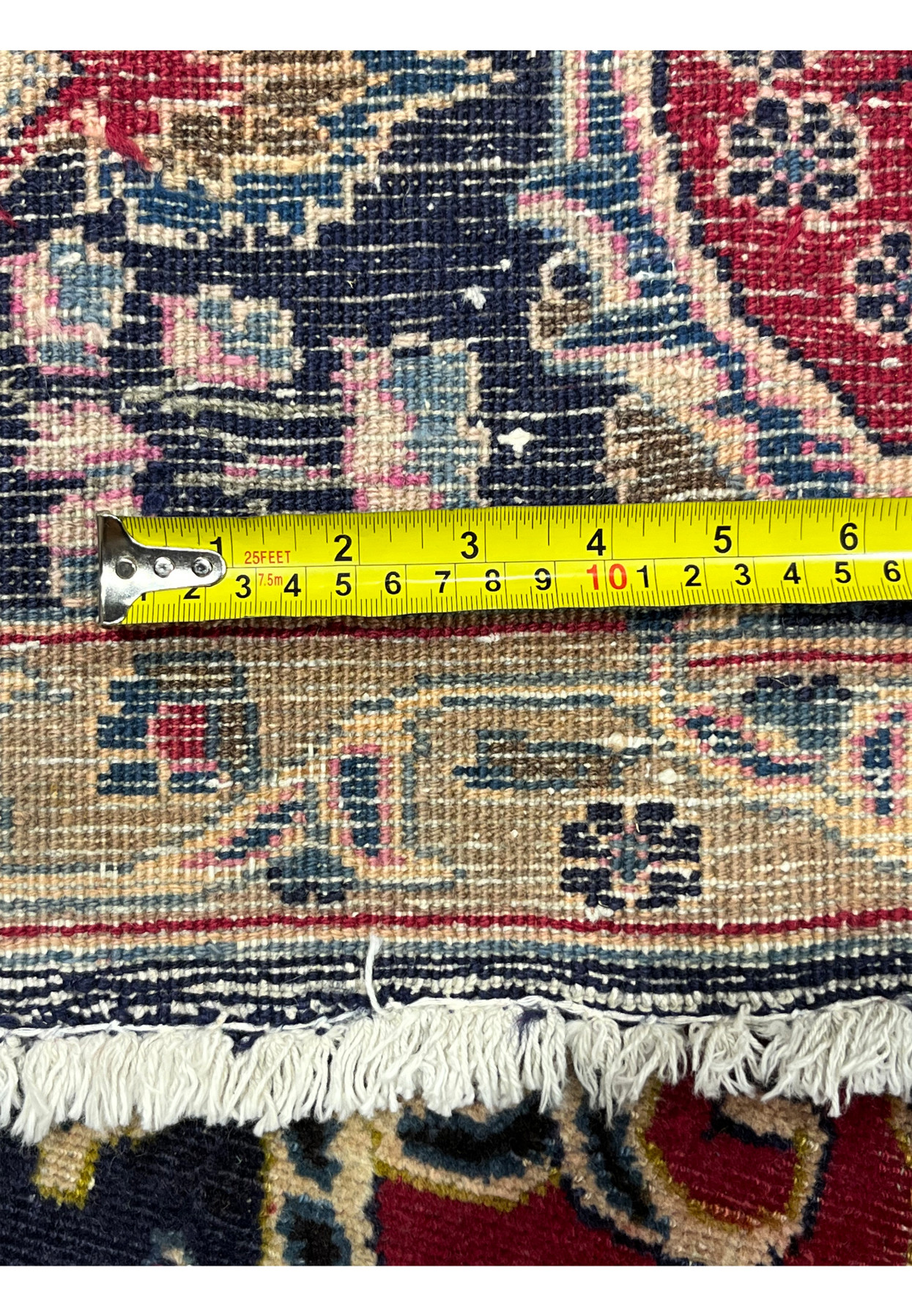 Tape measure on the back of the Kashmar Zirkhaki documenting its hand-knotted wool density