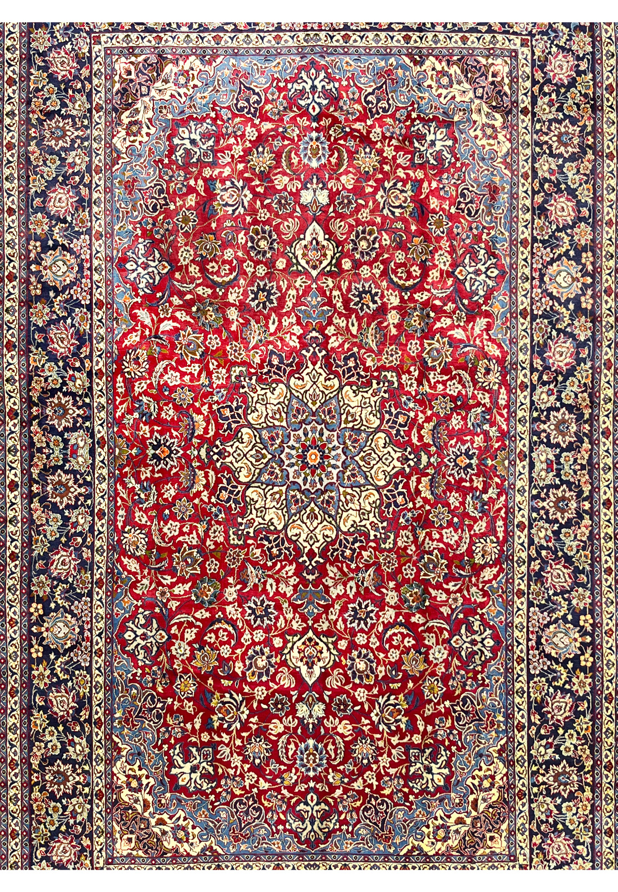 Central star medallion in blue and ivory surrounded by dense floral scrollwork on a deep red ground
