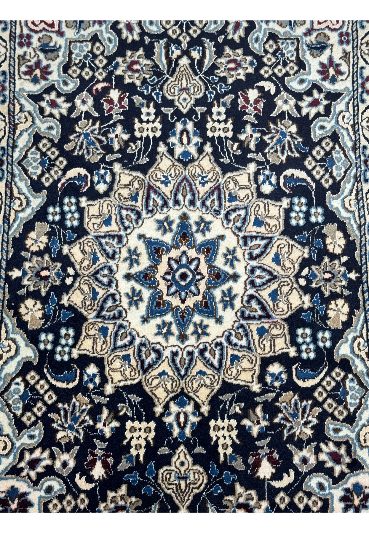 Ivory eight-point star medallion ringed by blue arabesques and palmettes, finely hand-knotted wool