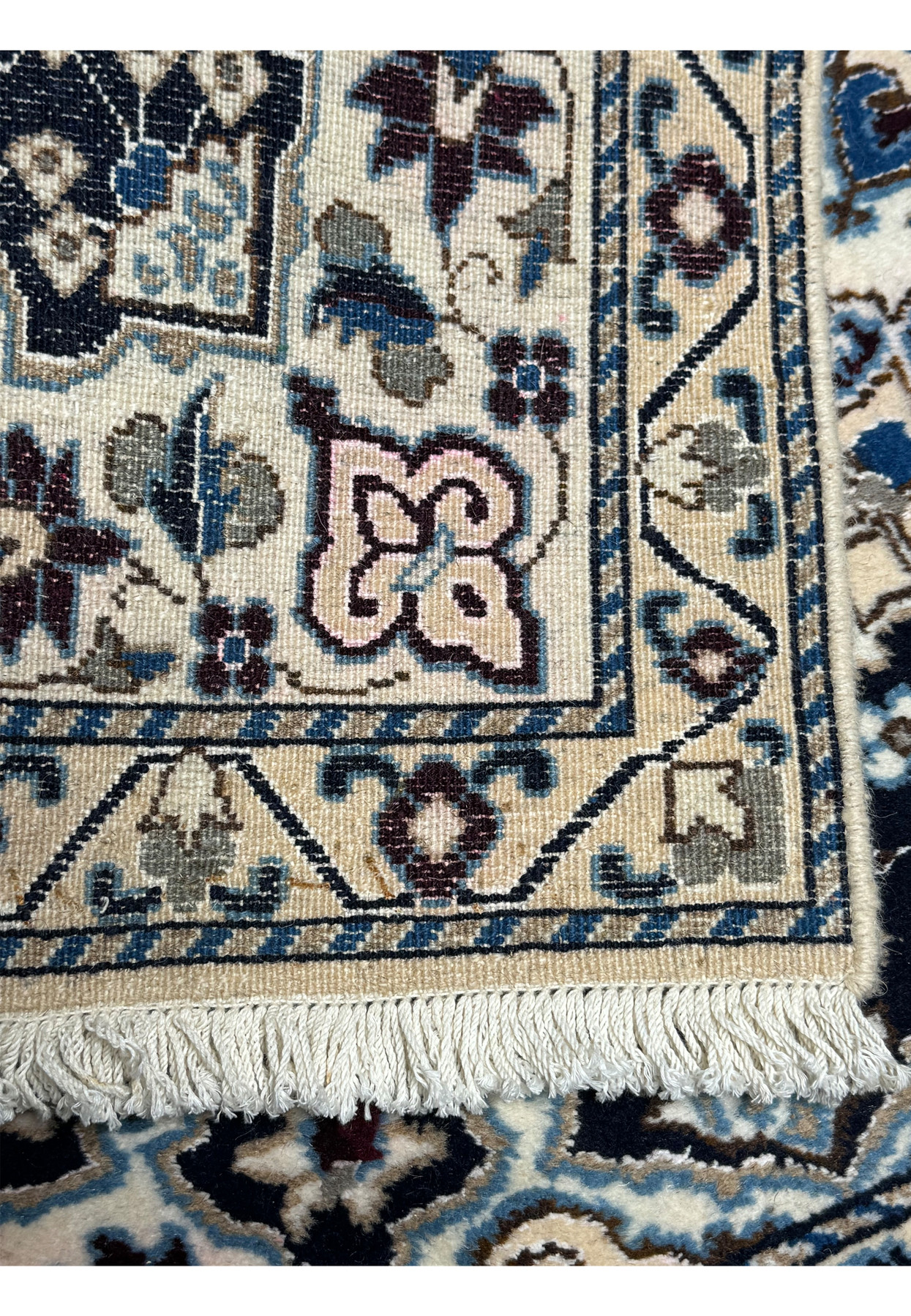 Reverse of the Nain rug showing the fine even knot count on a cotton foundation