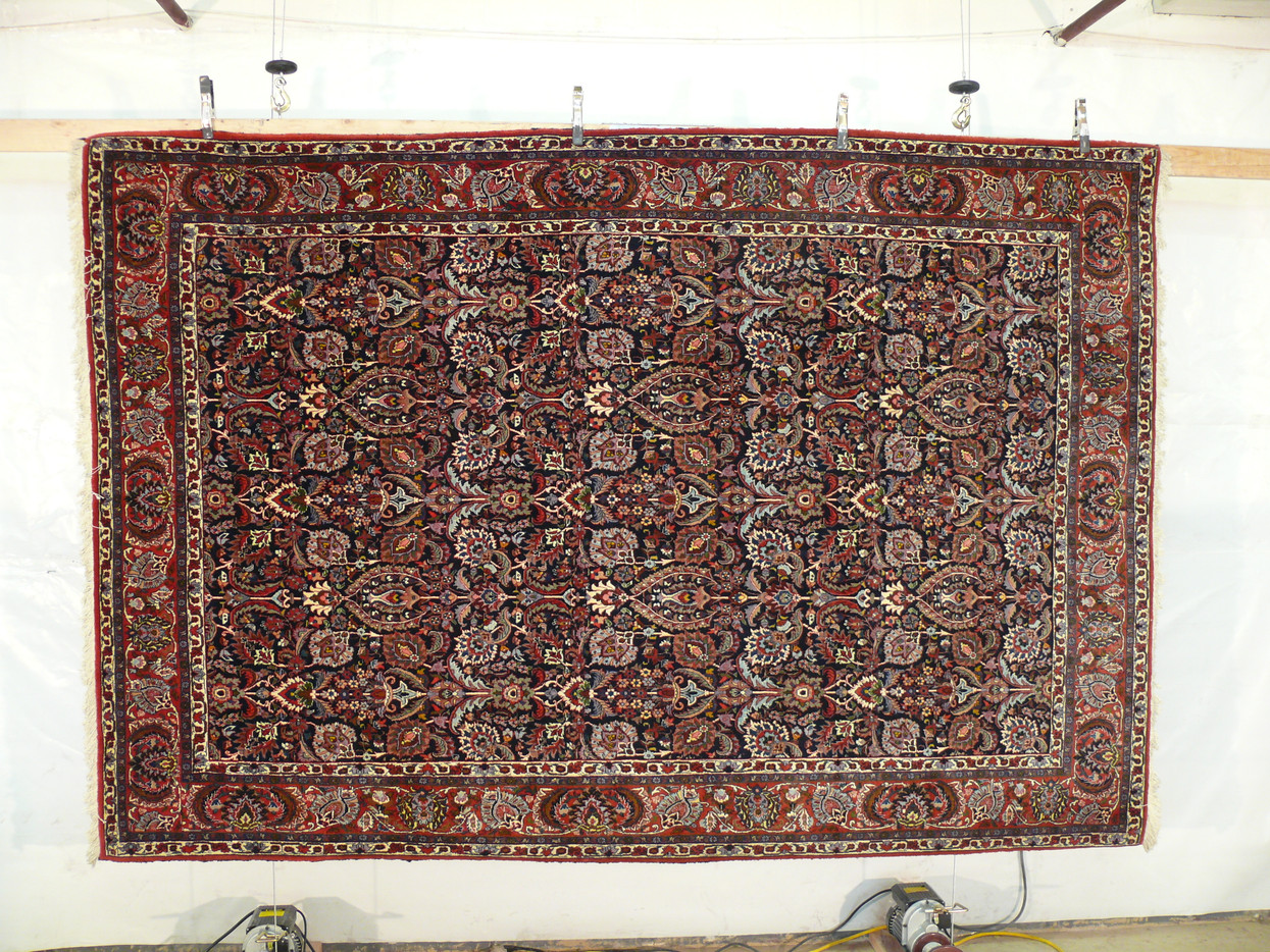 Magnificent Bijar Halvai shown hanging, navy field packed with vases and palmettes in glowing wool