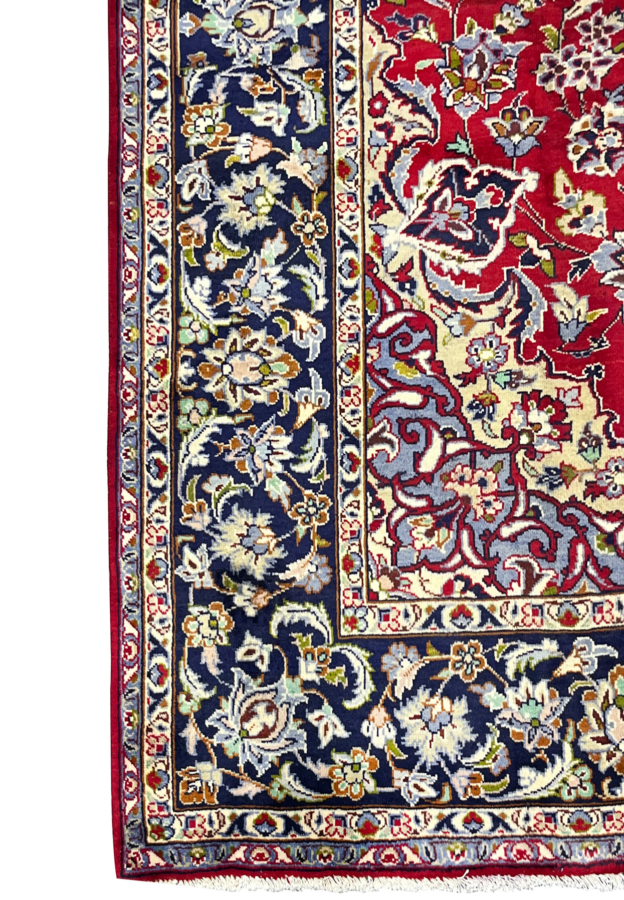 Midnight blue main border filled with palmettes and leafy vines beside the crimson floral field edge.