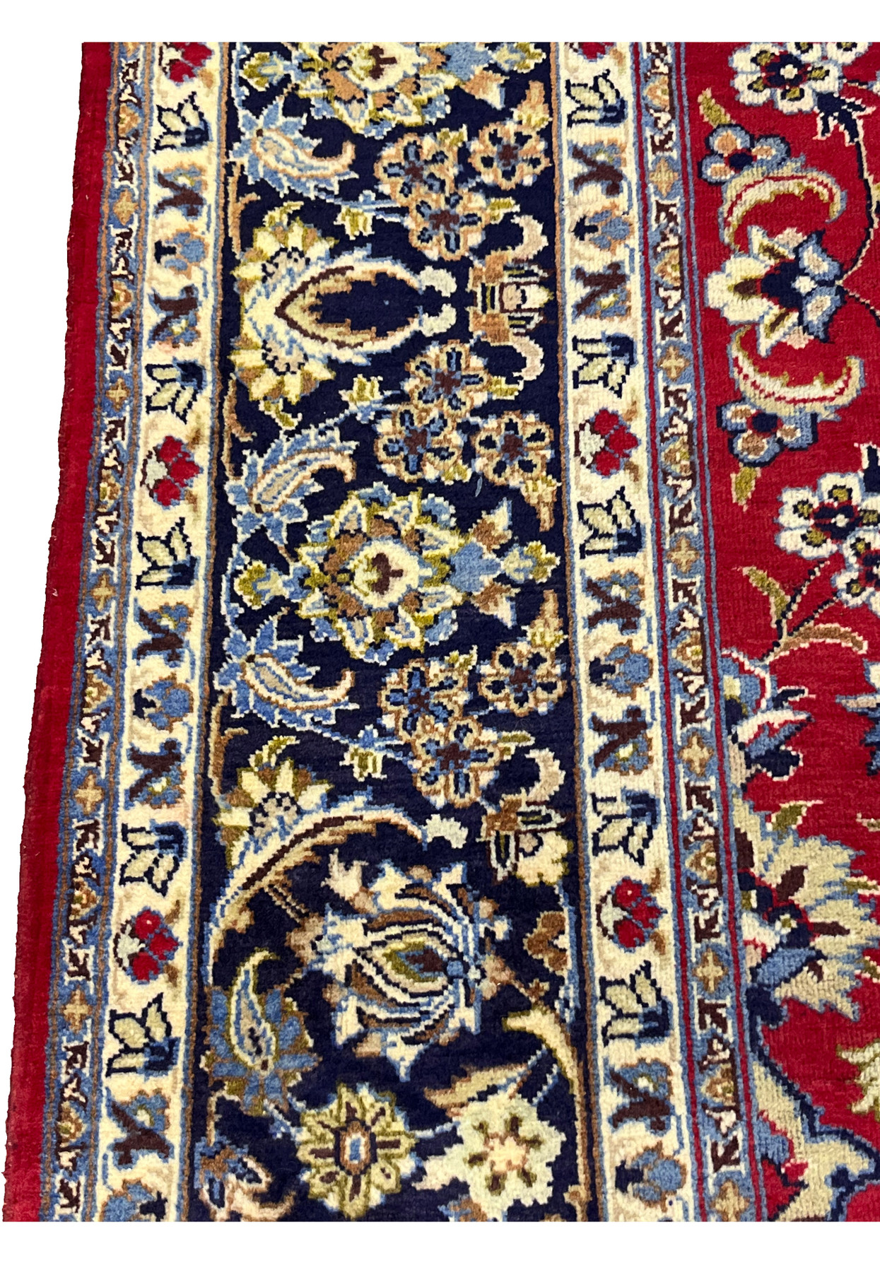 Navy main border with scrolling florals framed by ivory guard stripes on this Persian rug.