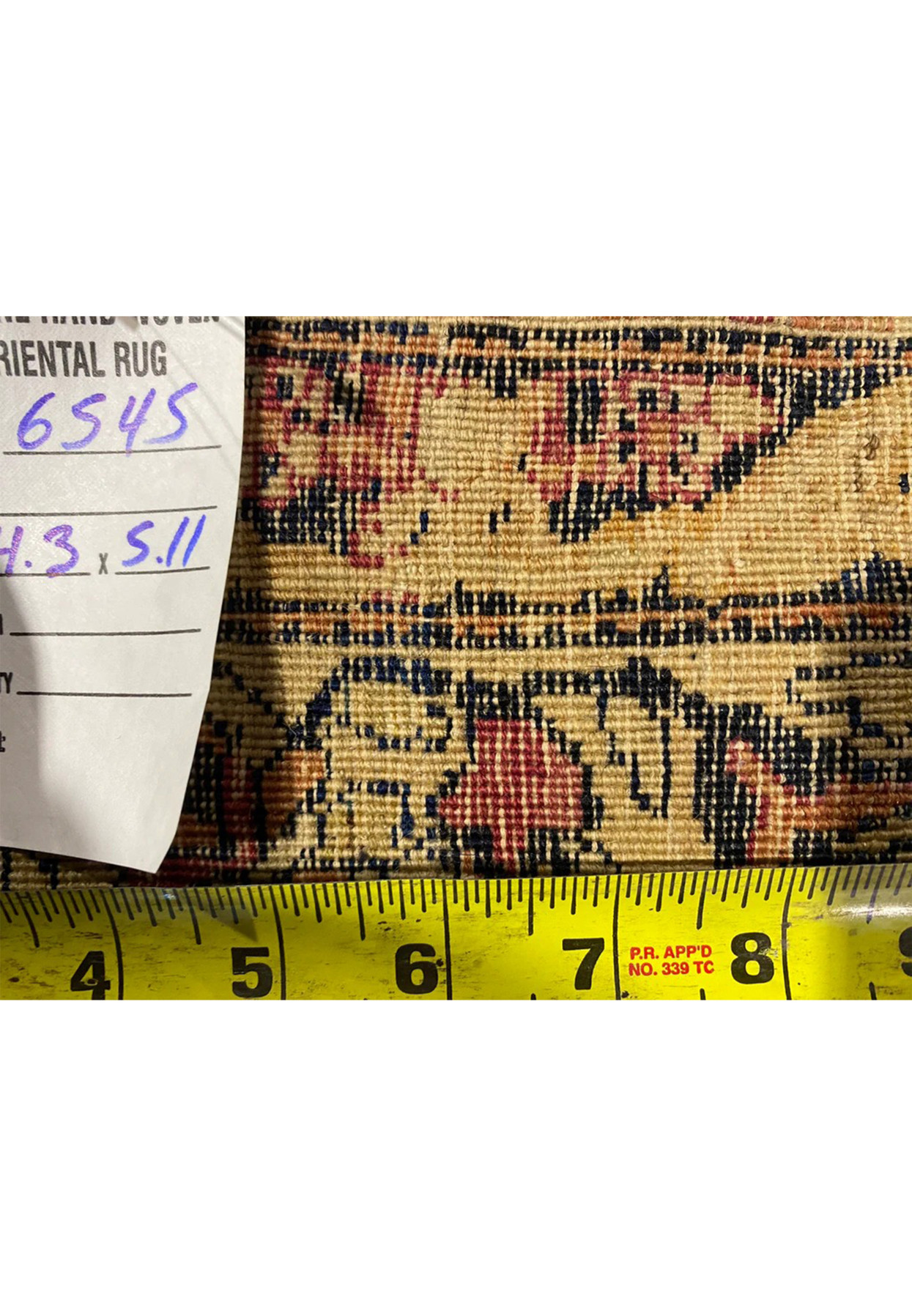 Reverse of the antique Tehran prayer rug with tape measure confirming the fine hand knotting.