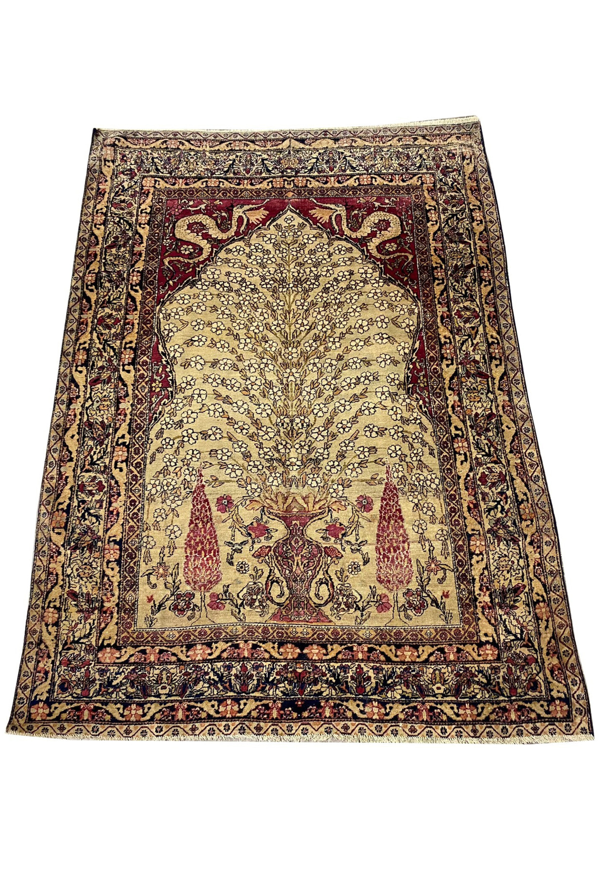 Tree of life Tehran prayer rug laid flat, ivory field with red arch spandrel and gold border.