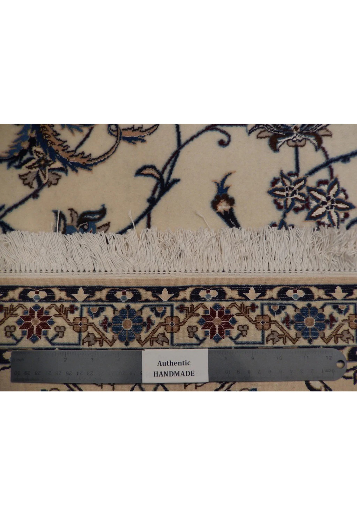 Backside of 7x10 Nain rug showing dense hand knotted weave of 550 to 600 knots per inch