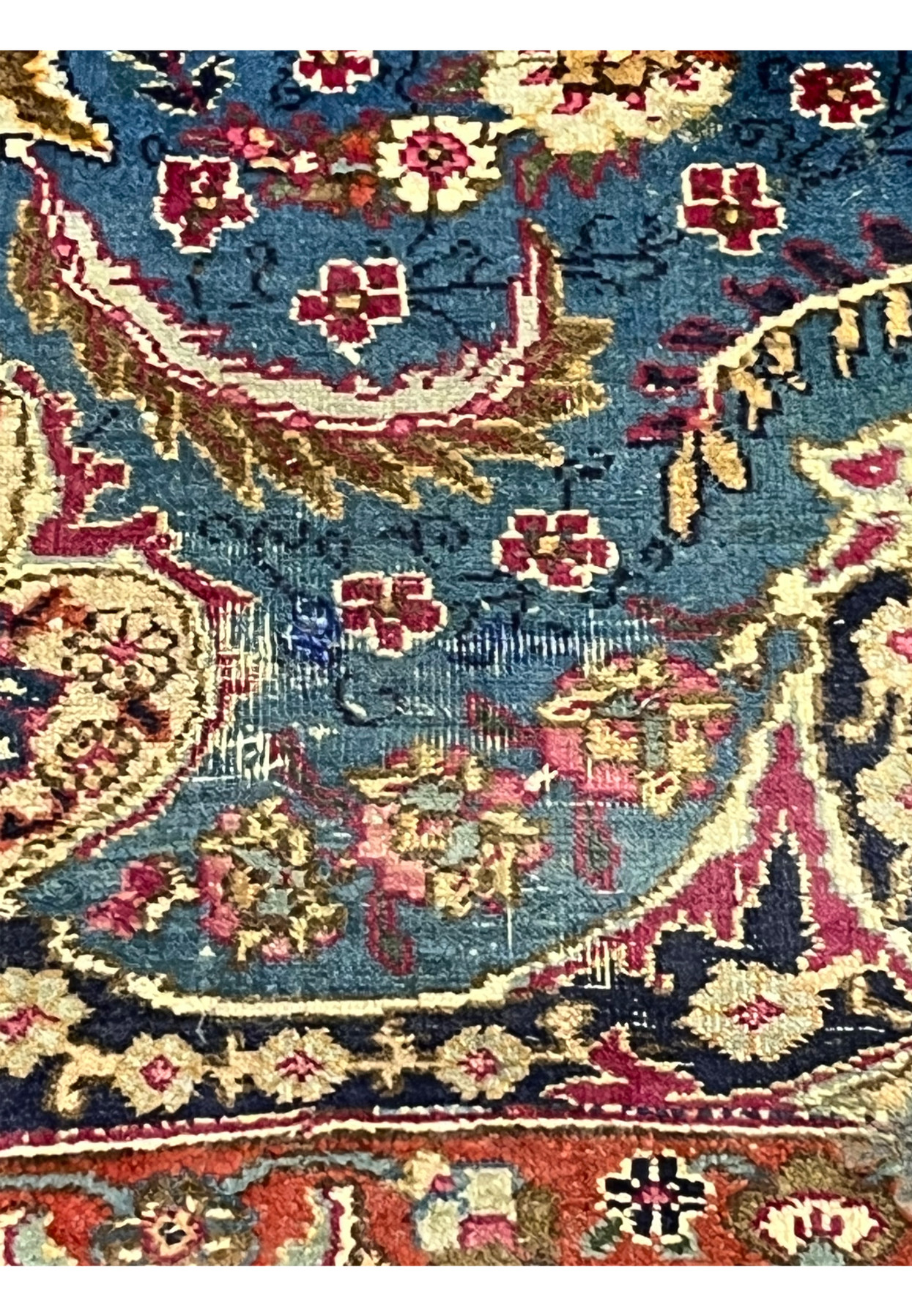 Closeup of worn field area showing foundation through low pile on distressed vintage rug