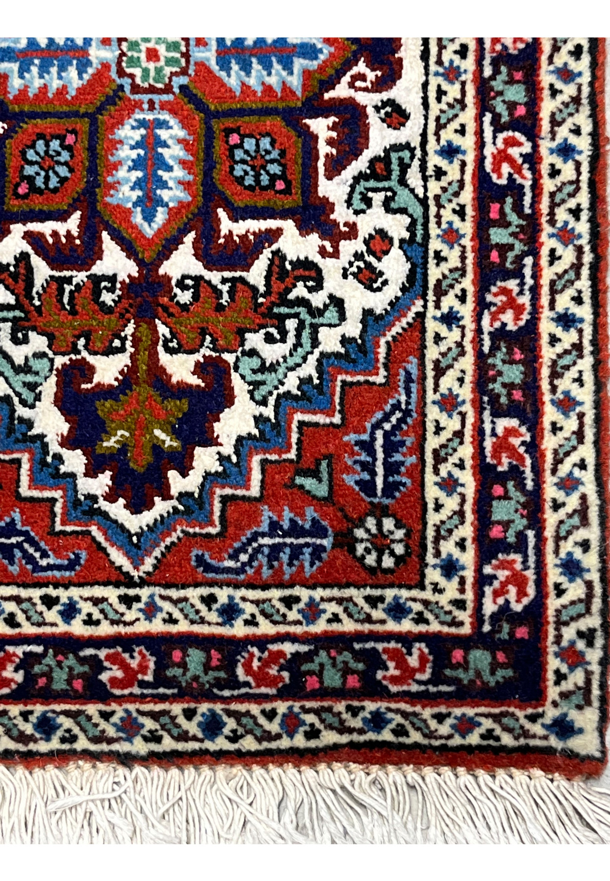 Ivory border detail with running flower vine and navy guard bands on miniature Ardebil
