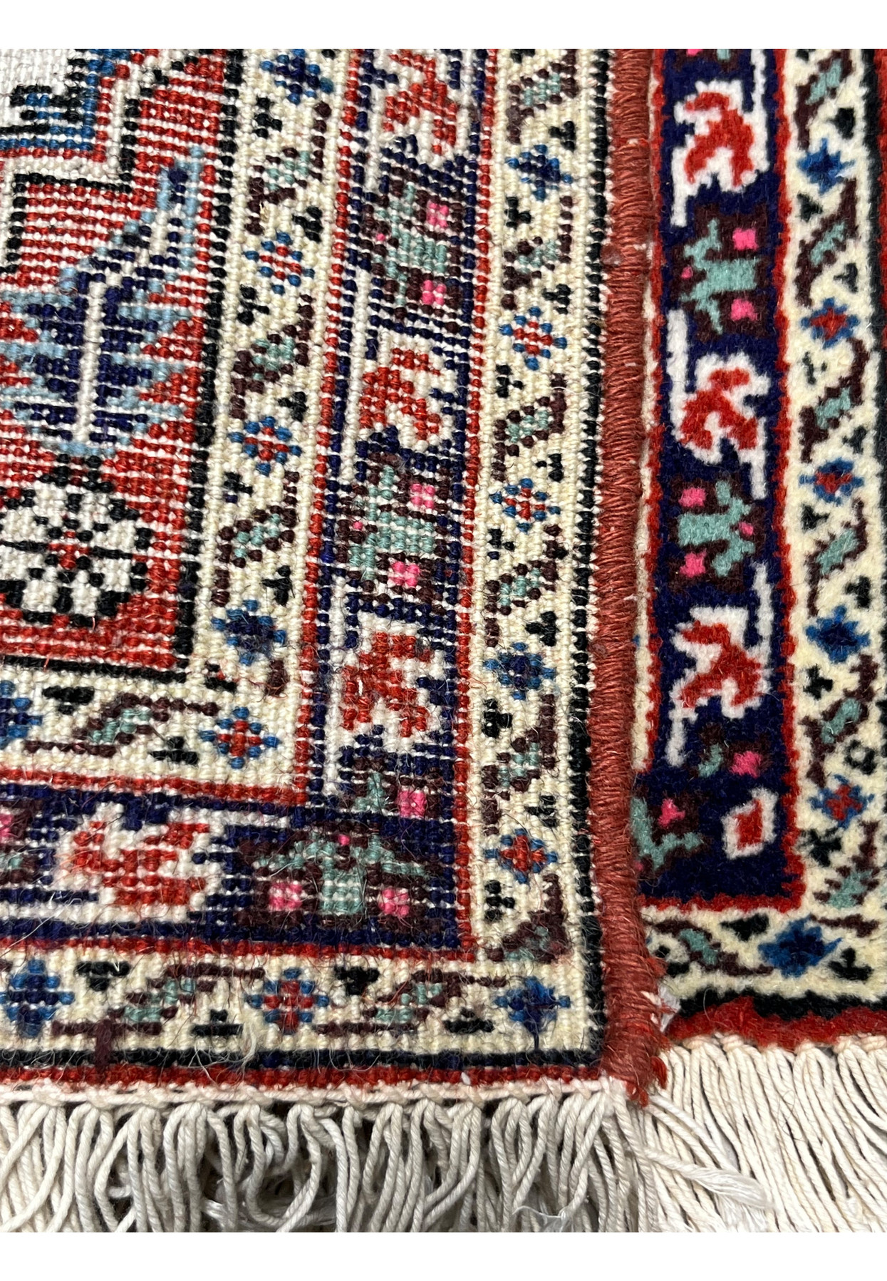Backside of tiny Persian Ardebil showing dense hand knotted construction and true colors