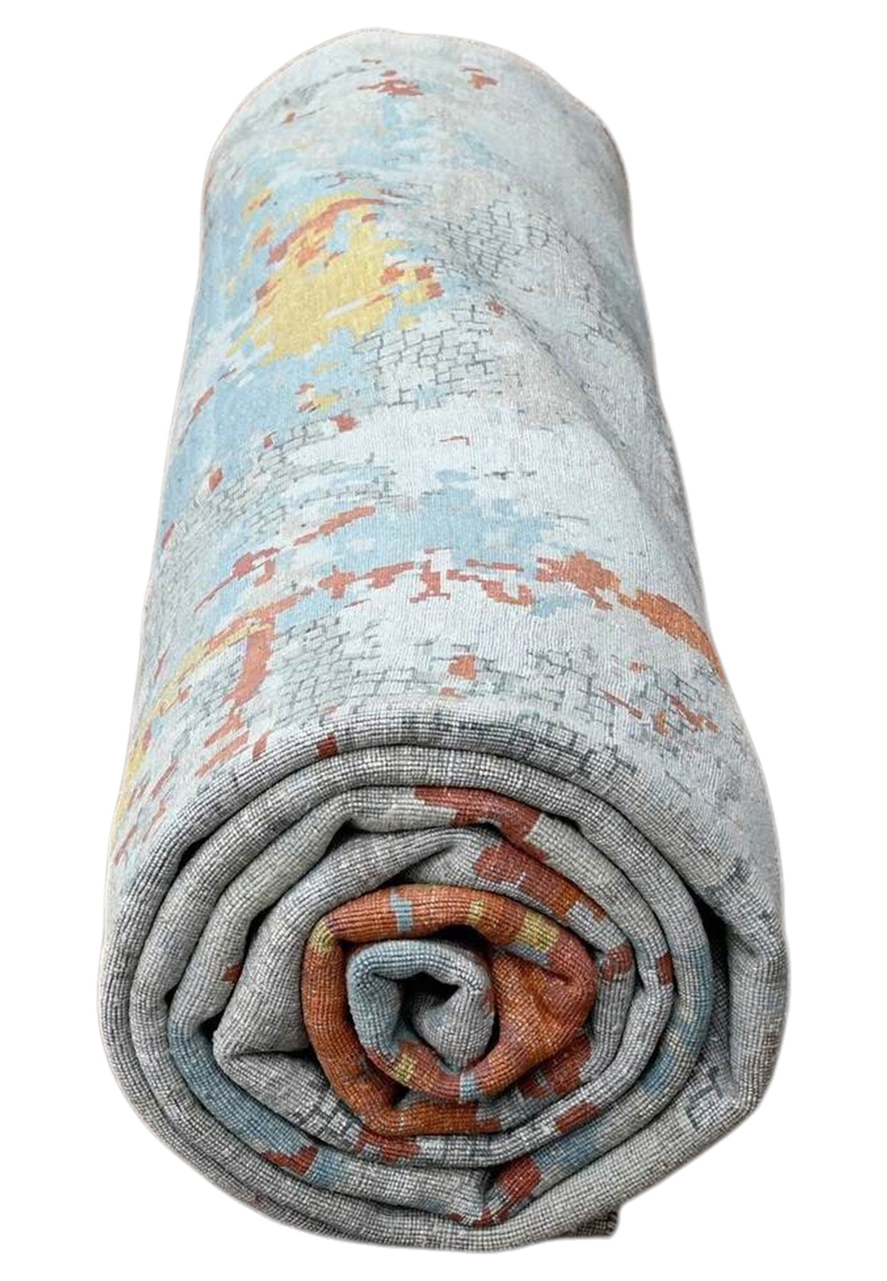 Rolled oversized modern rug showing light blue, yellow and orange abstract surface