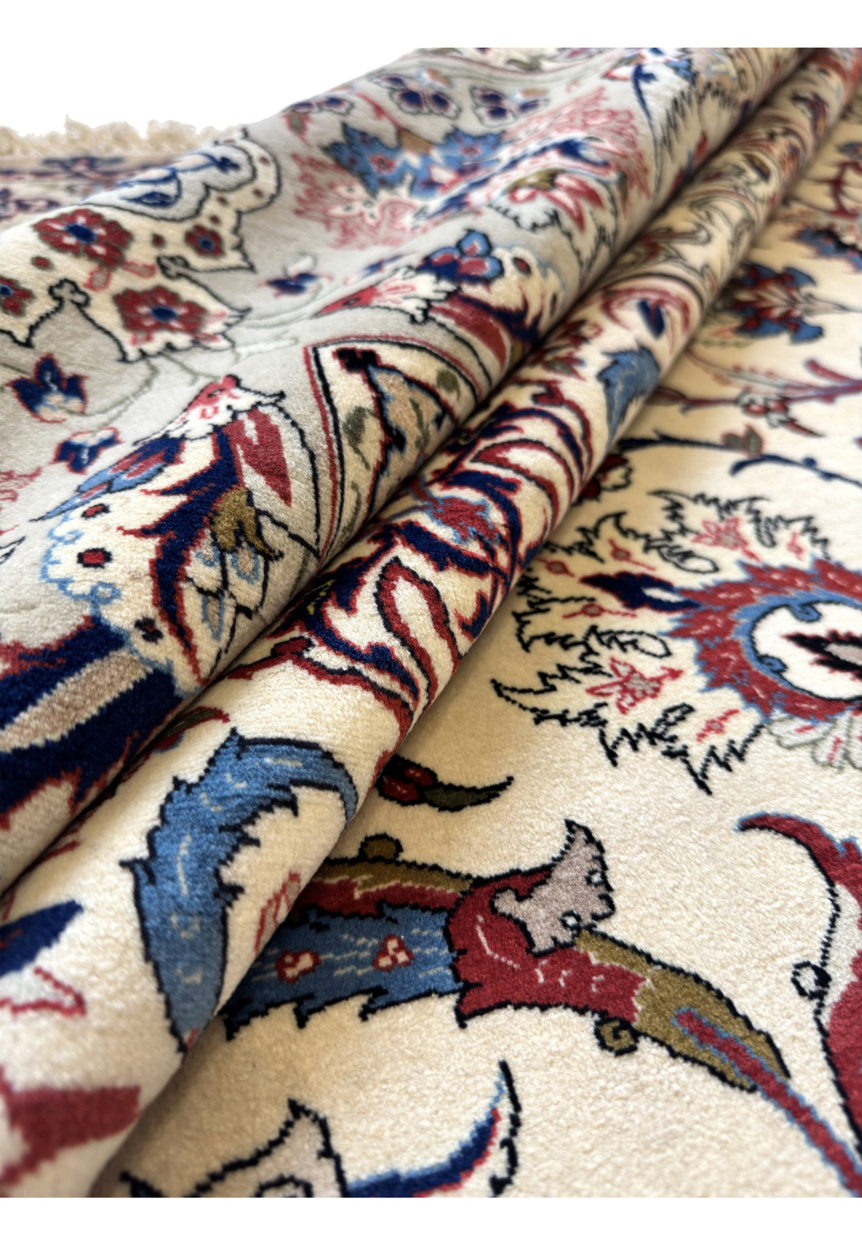 8'6x12'4 Persian Isfahan rug rolled at the corner, showing lustrous kork wool pile