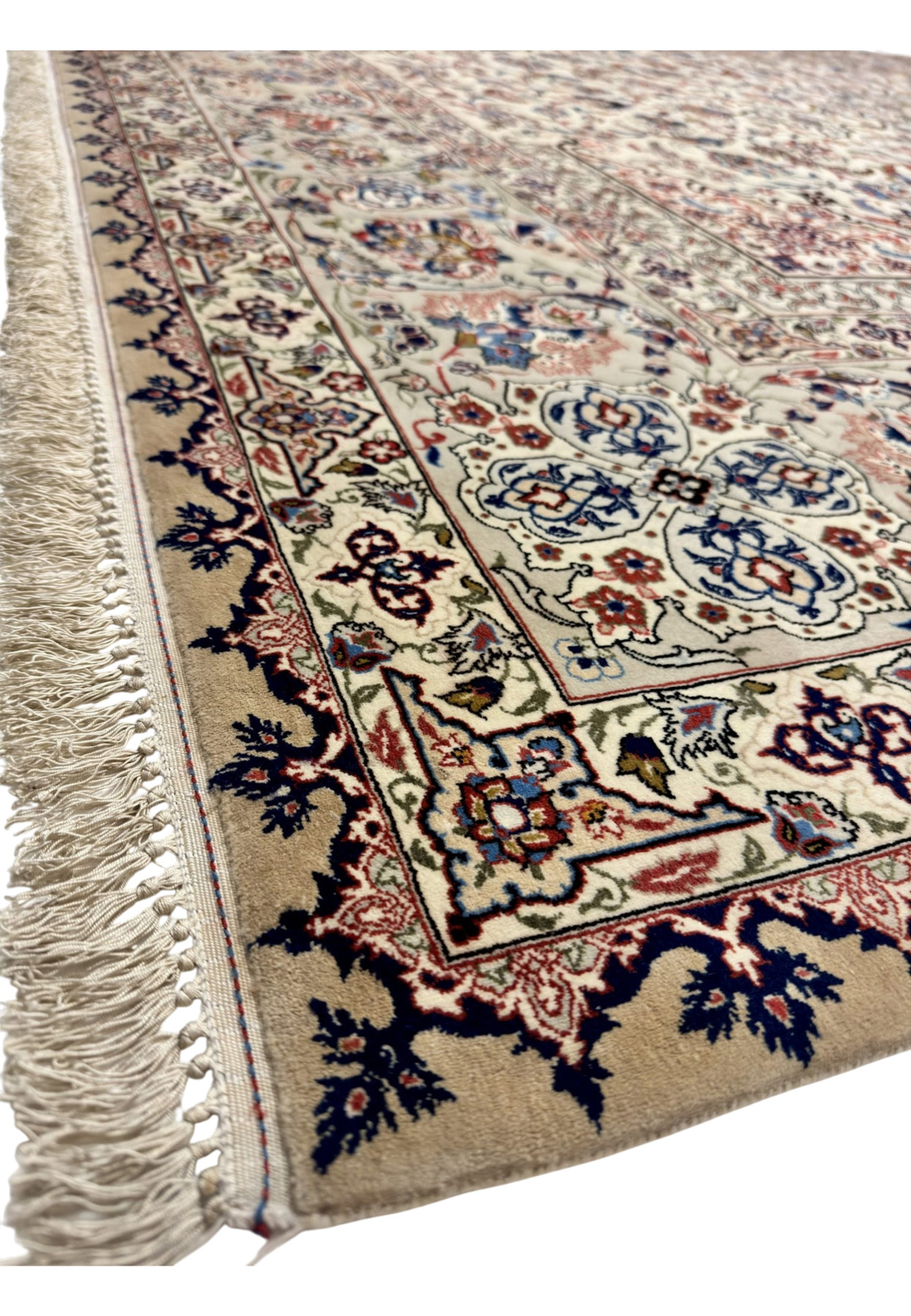Camel selvedge and thick ivory fringe along the edge of this hand knotted Isfahan rug