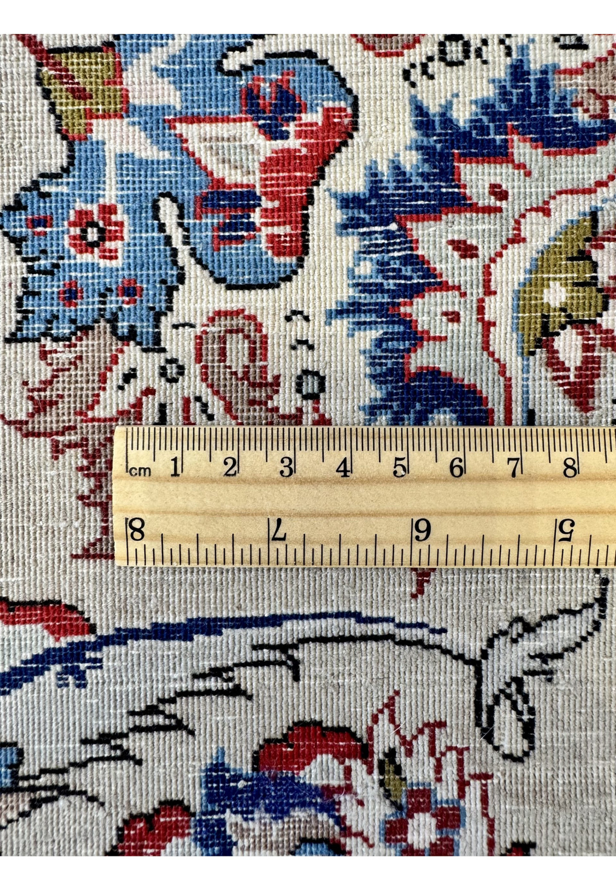 9x12 Persian Isfahan rug back with a ruler placed to demonstrate its very high knot density