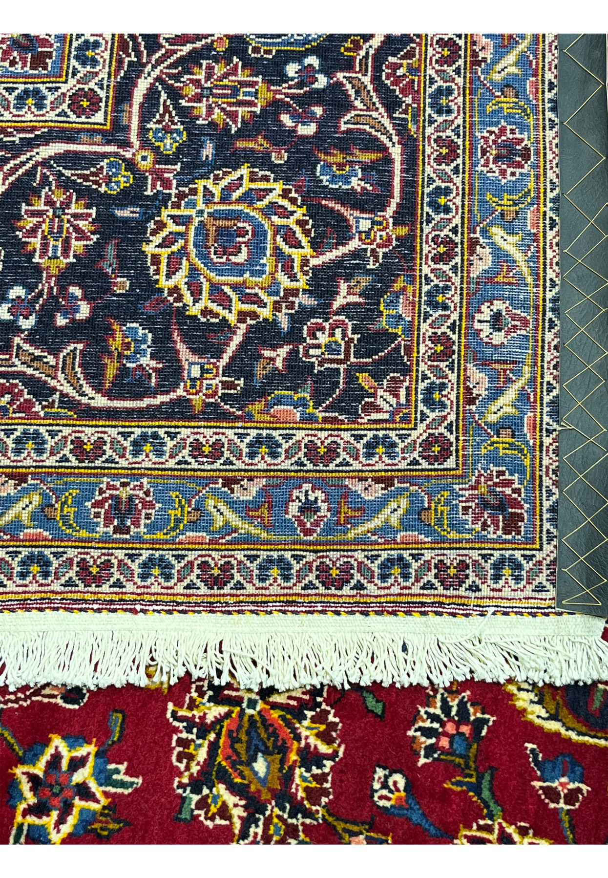 Reverse of the Kashan rug, cotton foundation with the pattern clearly visible through