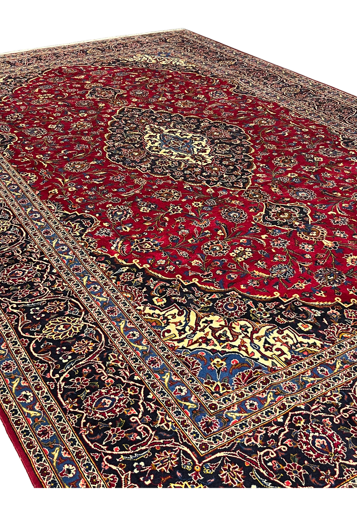 Angled view of the red and navy Kashan, ideal for a formal living or dining room
