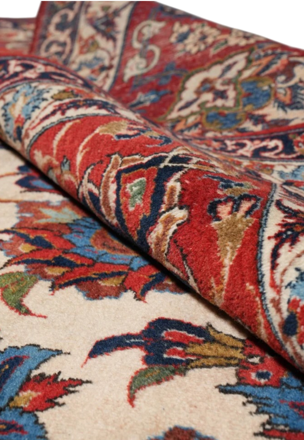 Rug rolled at the border, showing pile density and depth of the red main band