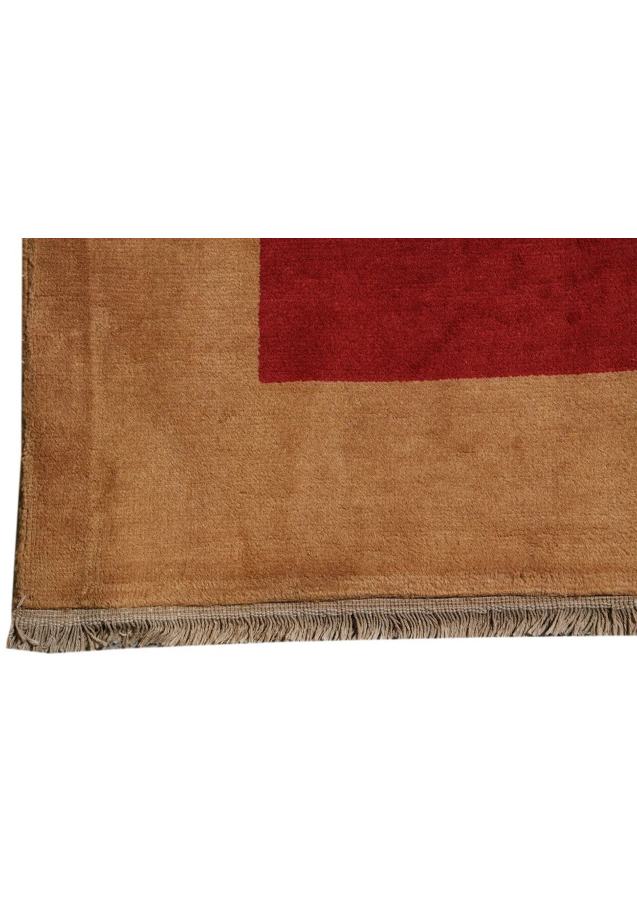 Plain camel border meeting the deep red field at the corner of this modern rug
