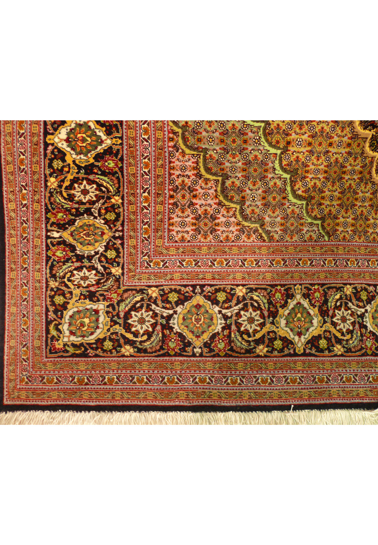 Corner detail of the black main border with gold, green and ivory palmettes and rosettes