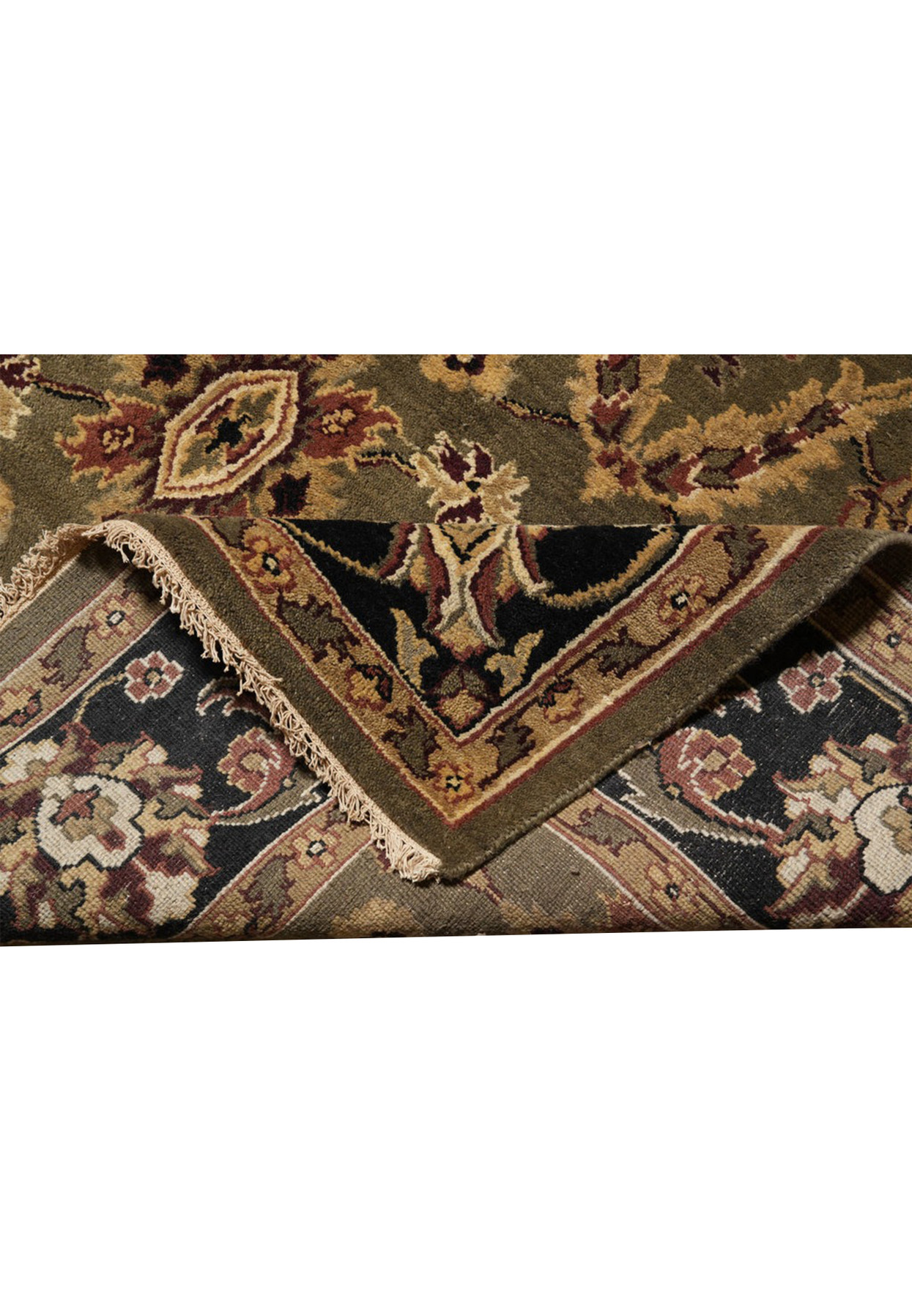 Folded corner showing the reverse of the hand-knotted Oushak rug and its ivory fringe