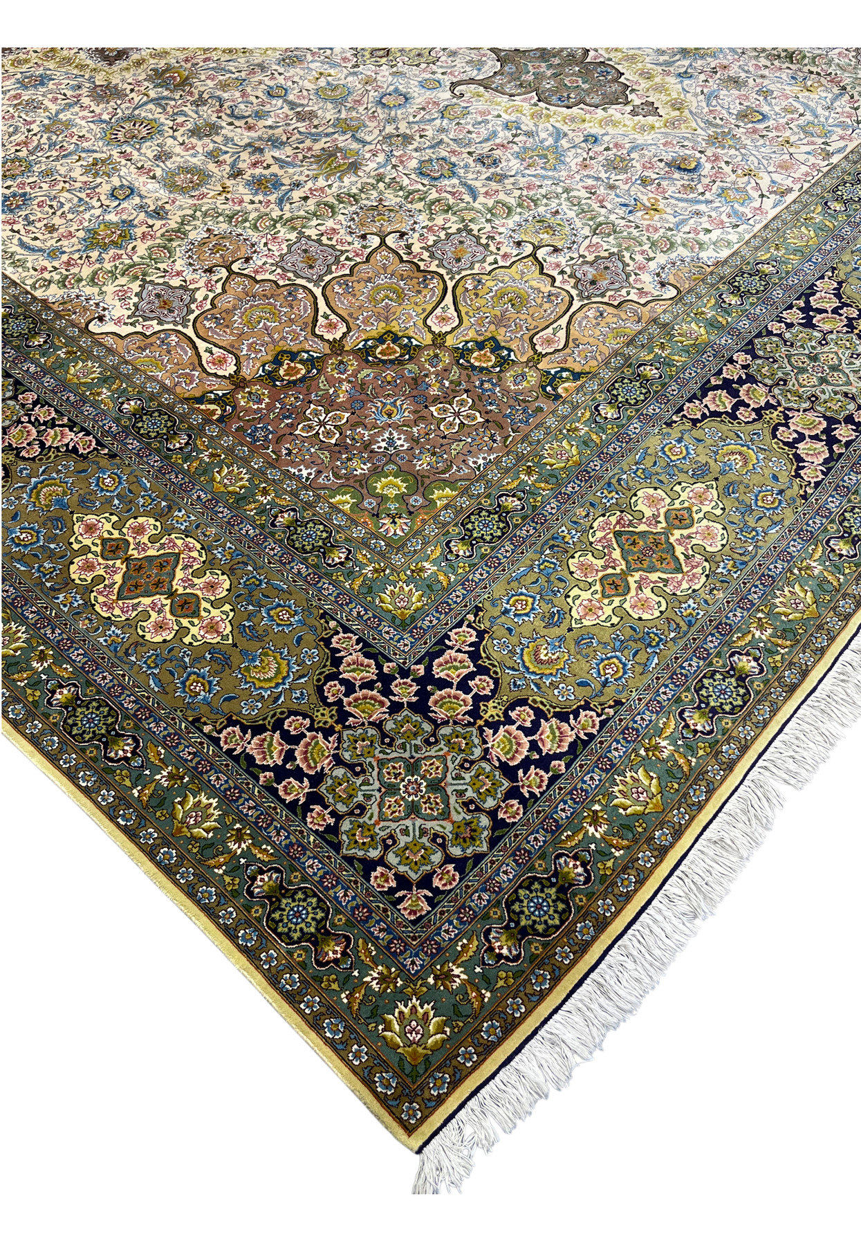 Corner where the ivory field meets the navy floral border of the pre-revolution Tabriz rug