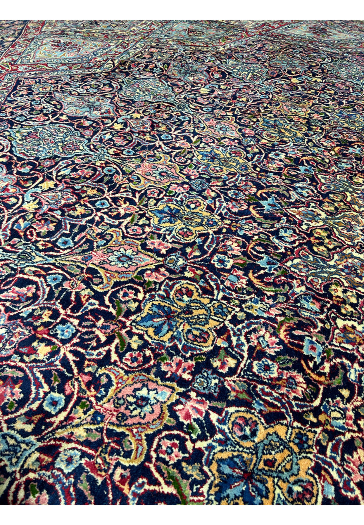 Navy field detail with dense palmettes, rosettes and curling leaves in aged wool