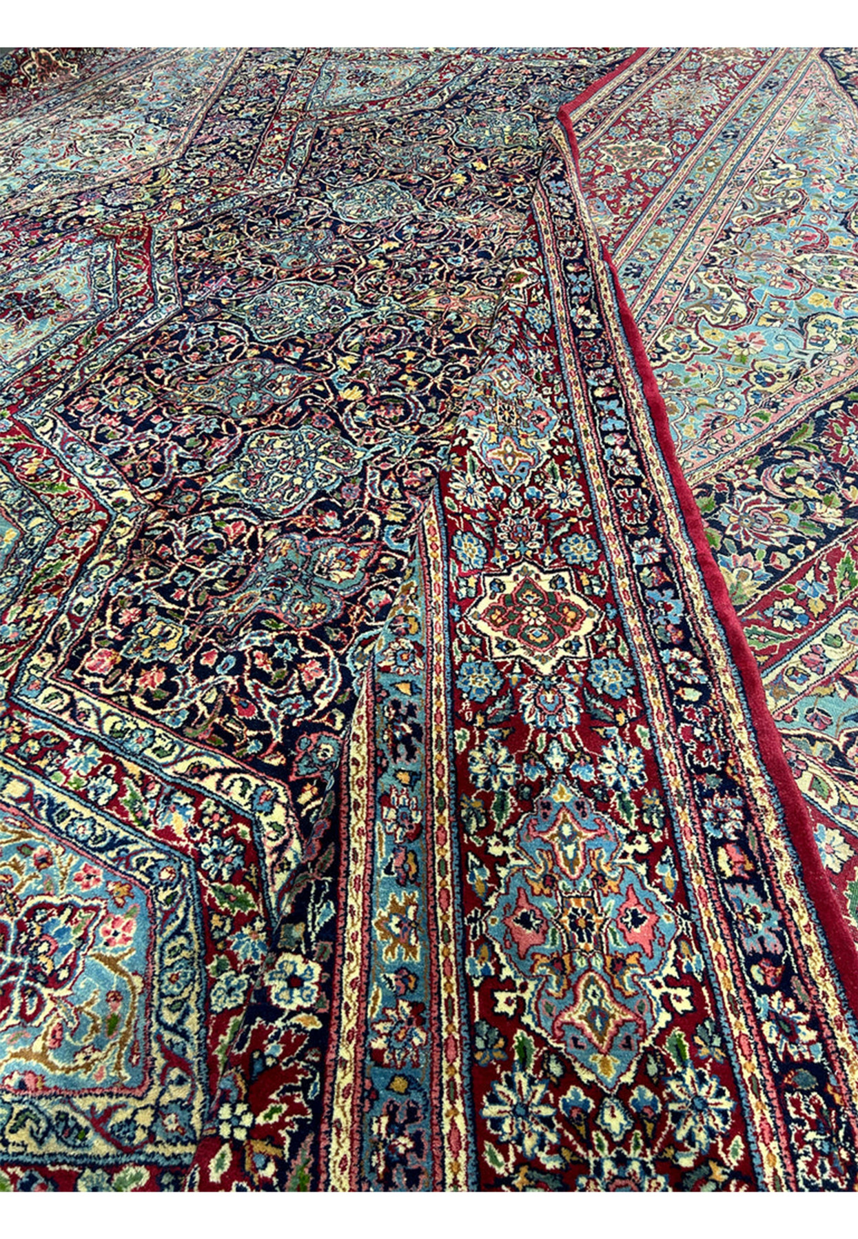 Back of the antique Persian Kerman rug showing the knot grid on a cotton foundation