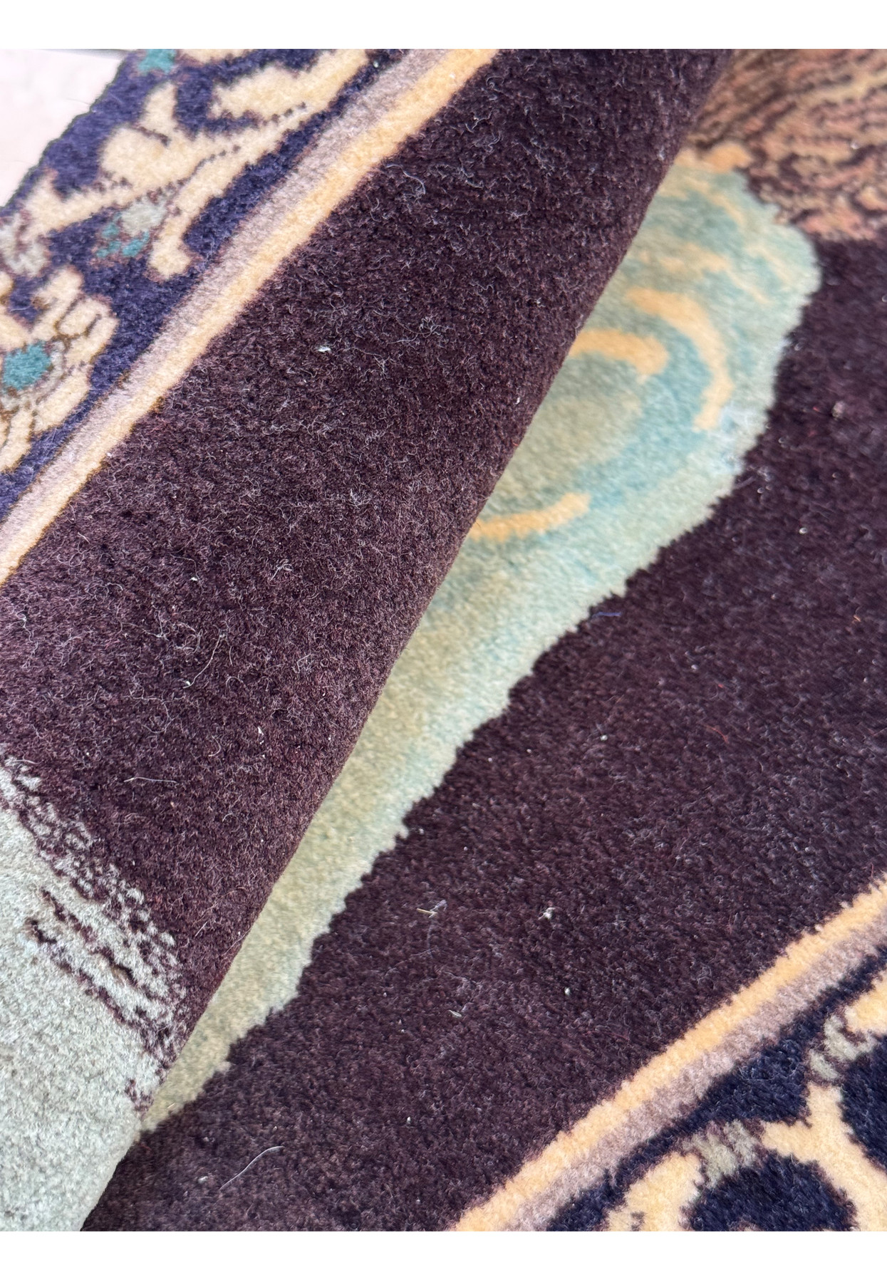 Fine wool pile of rolled Persian Tabriz pictorial rug in aubergine, blue, and teal