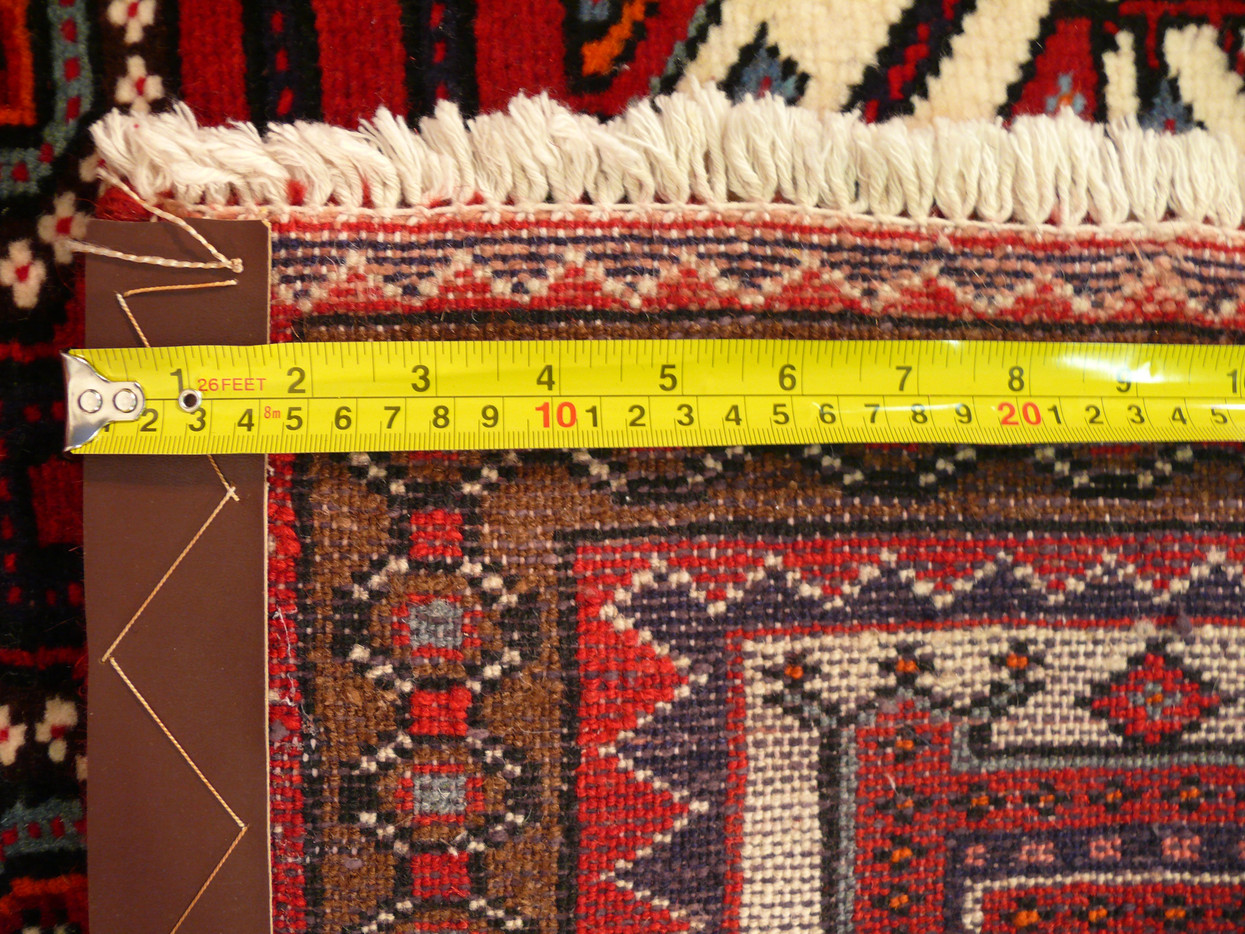 Another back view picture 3'4" x 5'1" Persian Shahsawan rug zoomed into the weave highlighting the knot density with a ruler