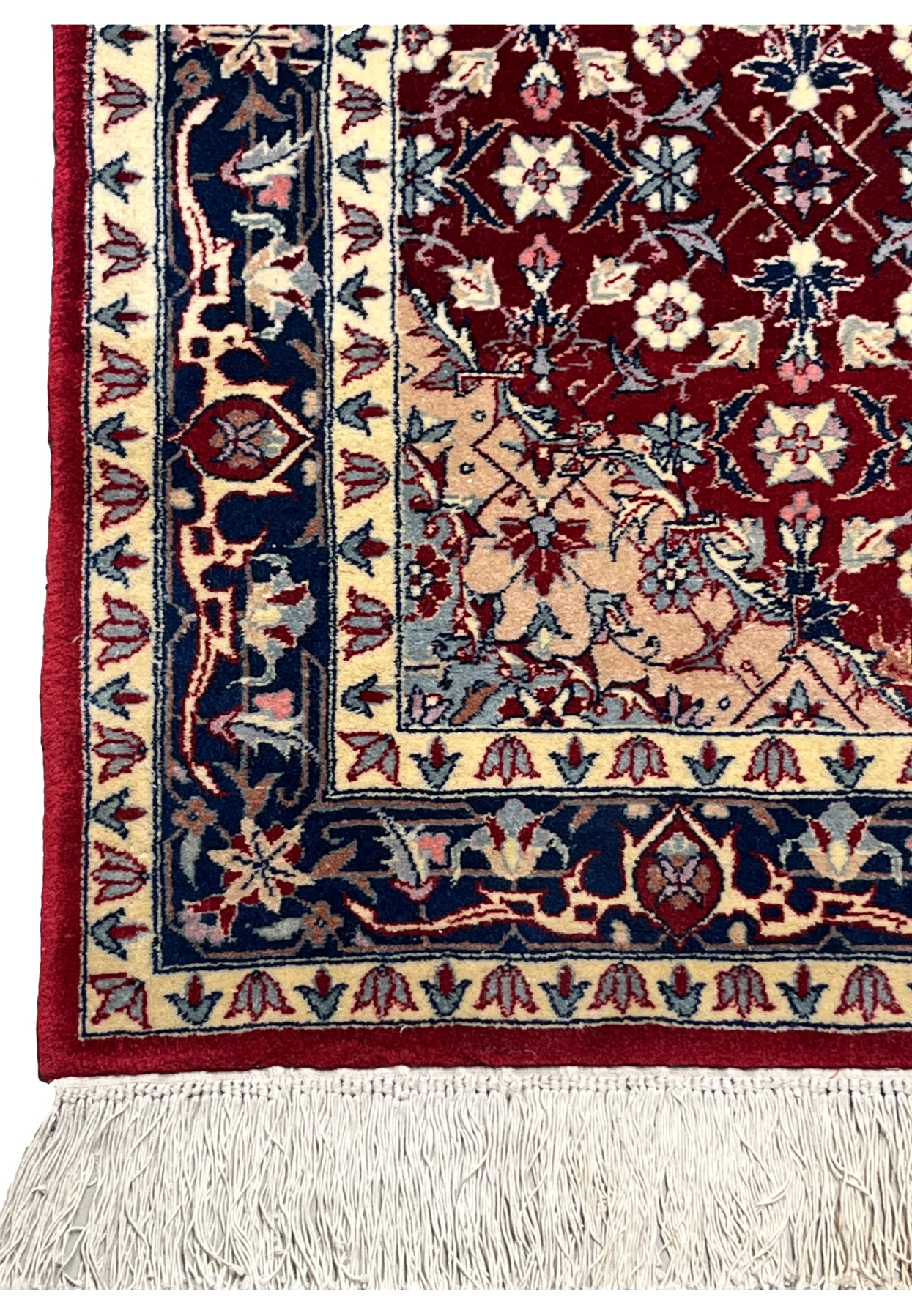 Close view of the layered border on a Persian Tabriz rug featuring navy blue ground, ivory floral patterns, blush accents, and refined weaving detail