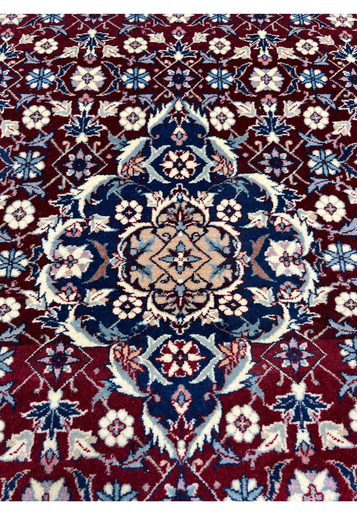 Central medallion close up of a Persian Tabriz rug featuring navy and ivory floral composition, symmetrical layout, and fine hand knotted detail