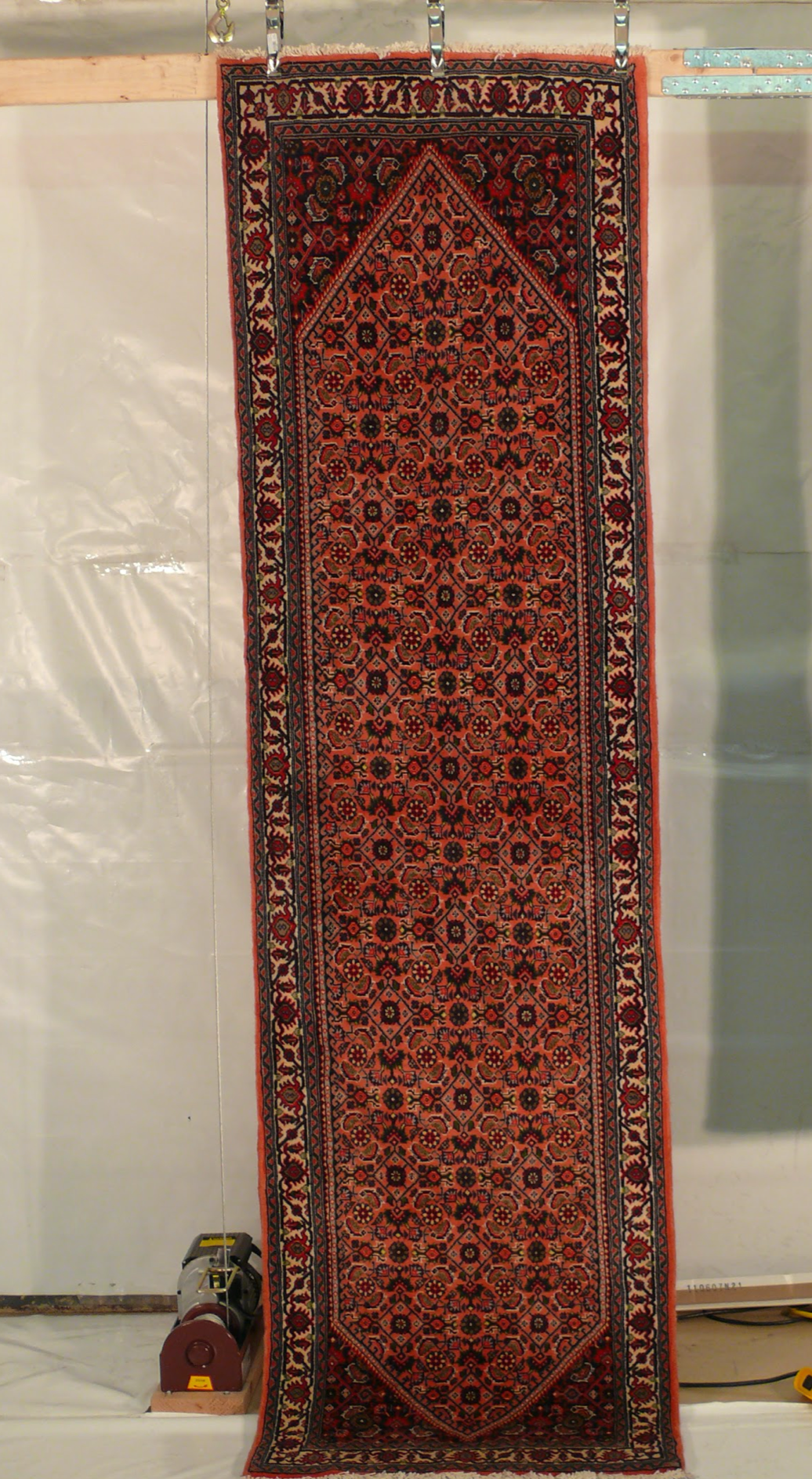 The Persian Bijar Runner Rug in a room setting, illustrating its decorative appeal and fit.