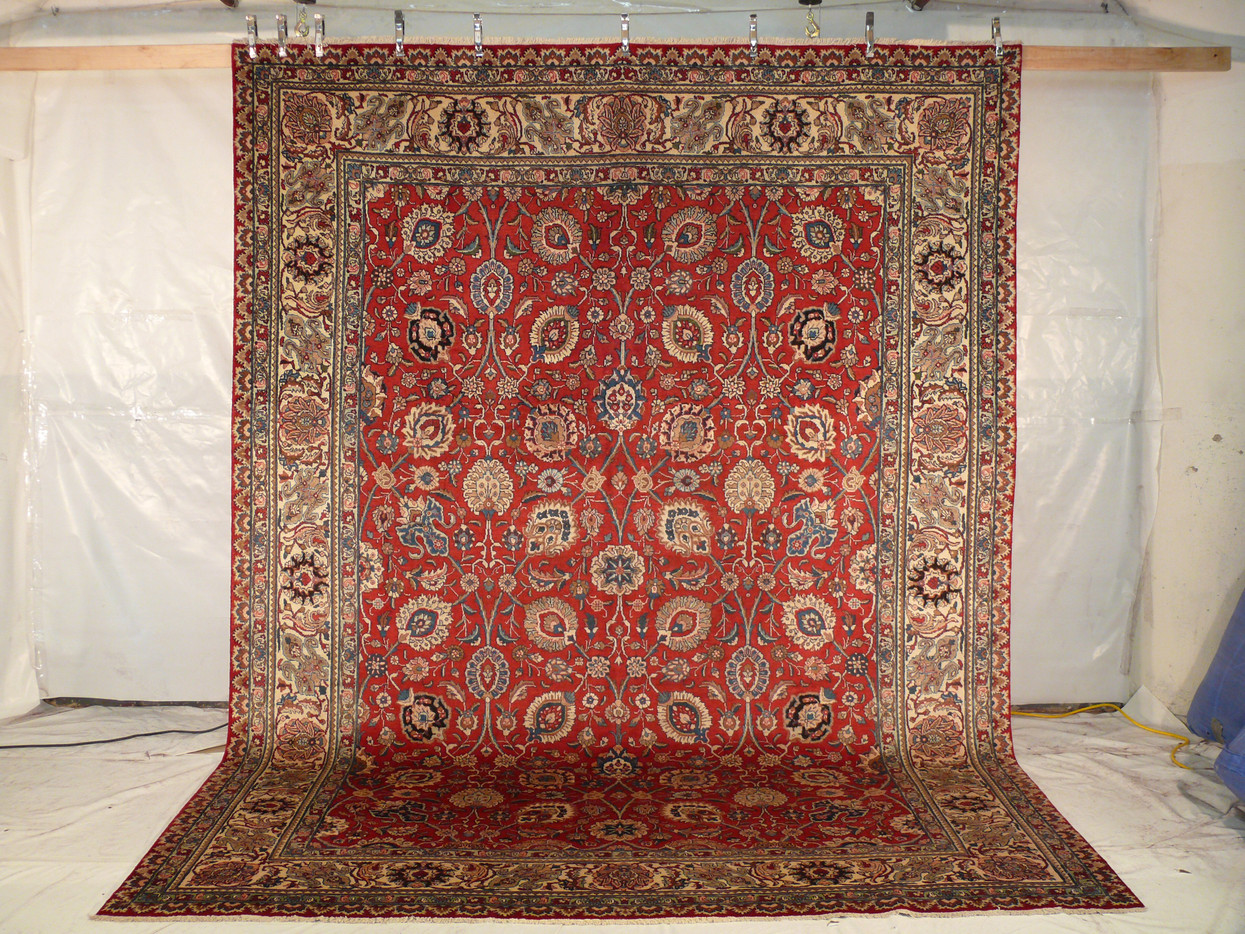 Closer view of the hanging Tabriz showing soft natural abrash across the red ground