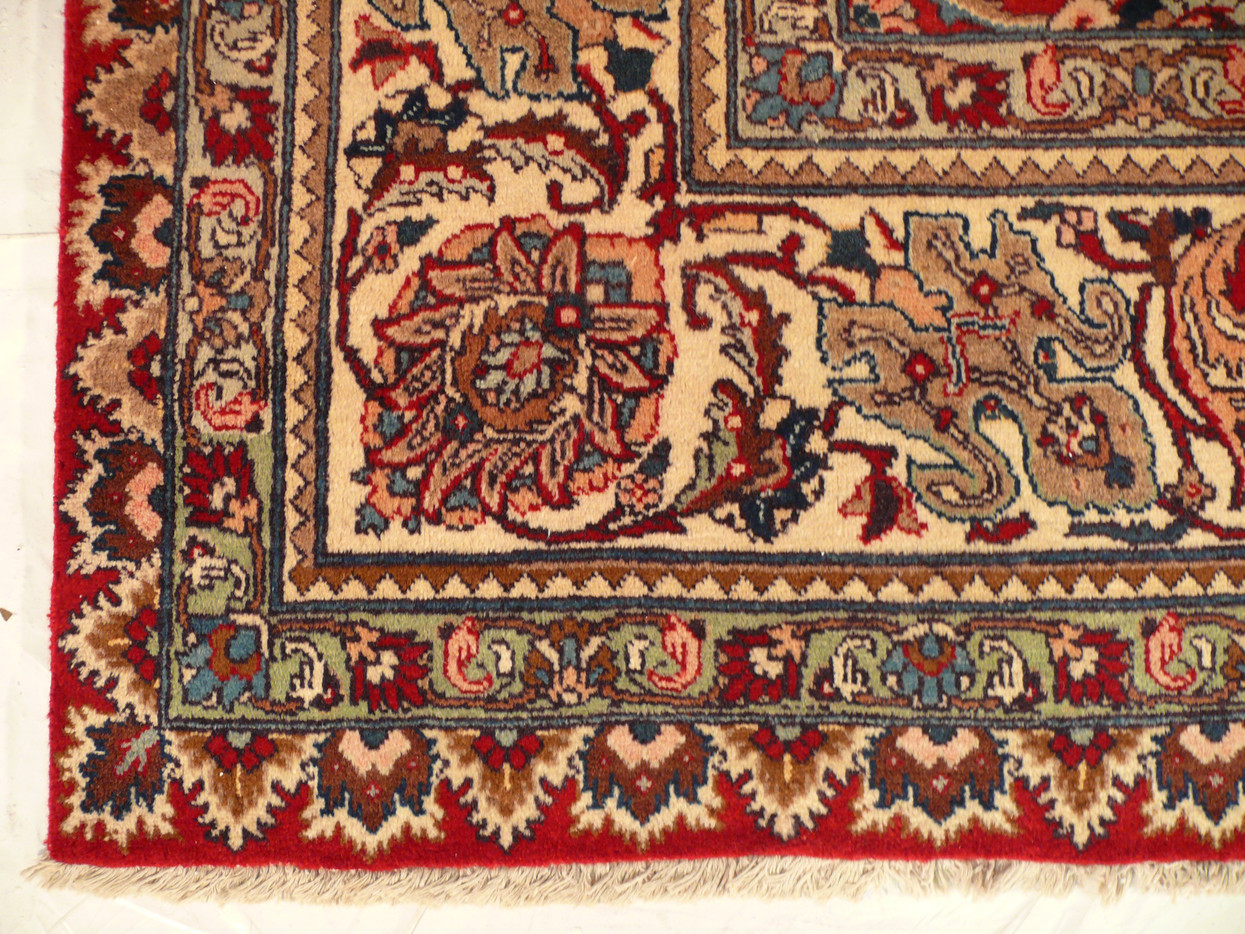 Navy main border of the vintage Tabriz with floral sprays between lighter guard bands