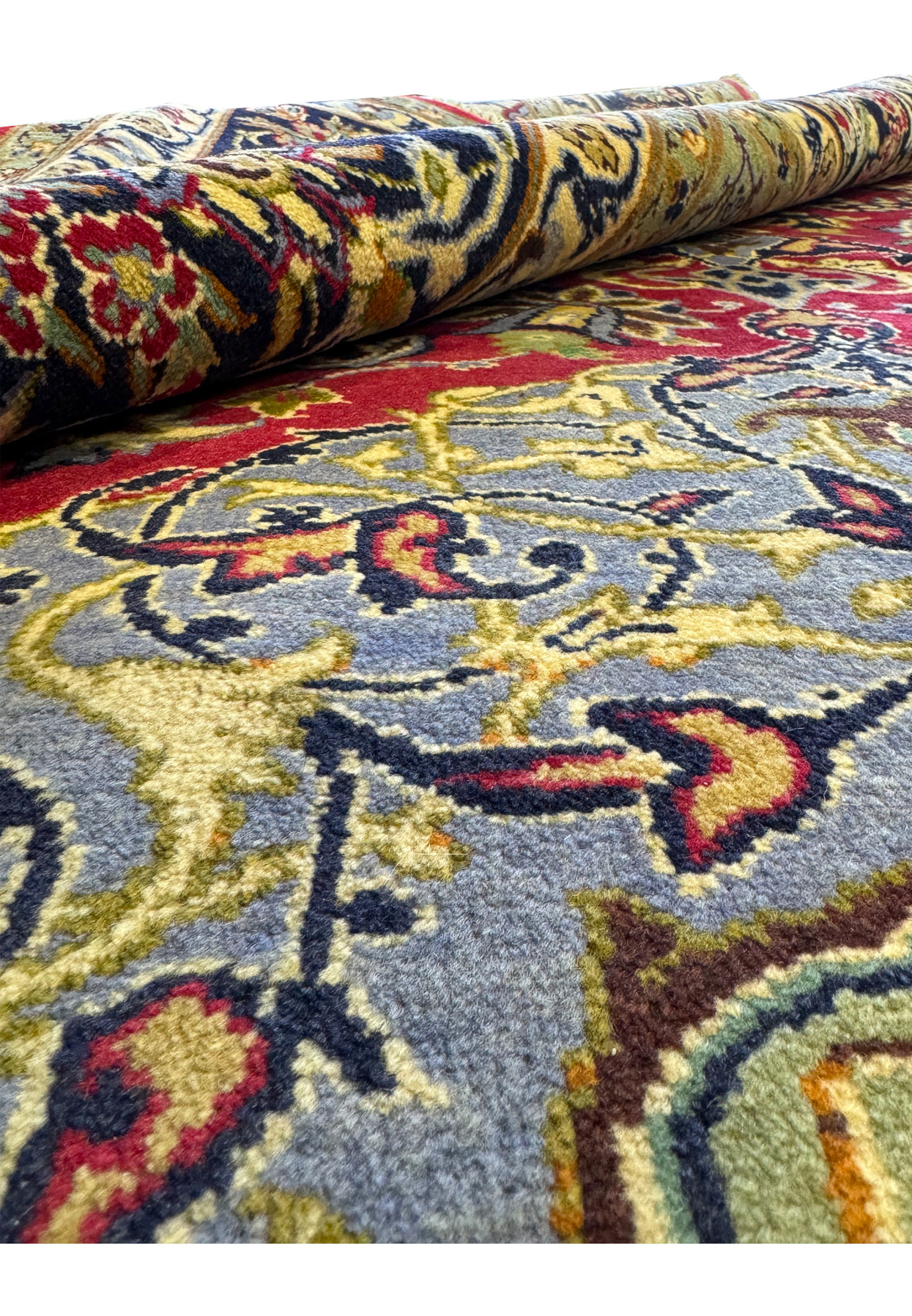 Rolled Persian 10x13 Isfahan Rug showing texture and intricate patterns up close