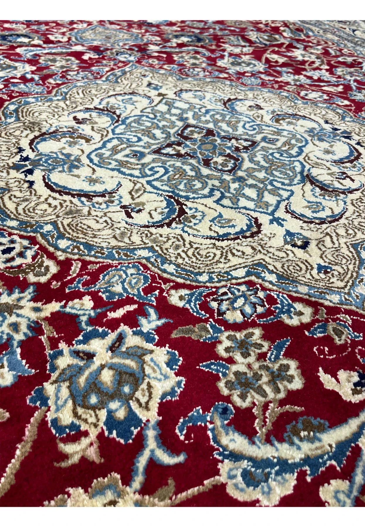 Foundation close-up of Persian Nain rug revealing tight hand knotted structure and fine wool and silk weave