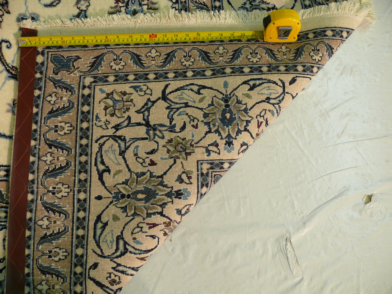 Backside of rug showing weave density and foundation under beige field