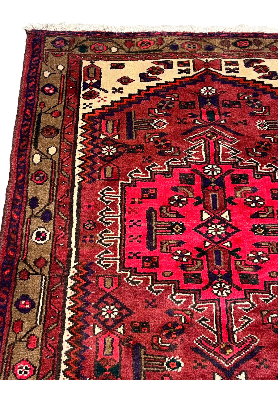 Side detail of an antique Persian Hamedan tribal rug showing dense wool pile, crisp geometric pattern edges, and well-preserved village craftsmanship