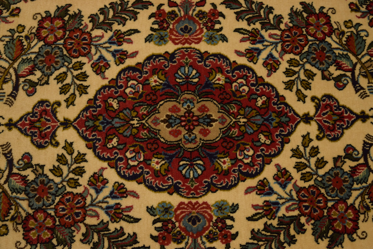 Close-up of the intricate floral designs and vibrant colors on the Persian Qum Kork rug.
