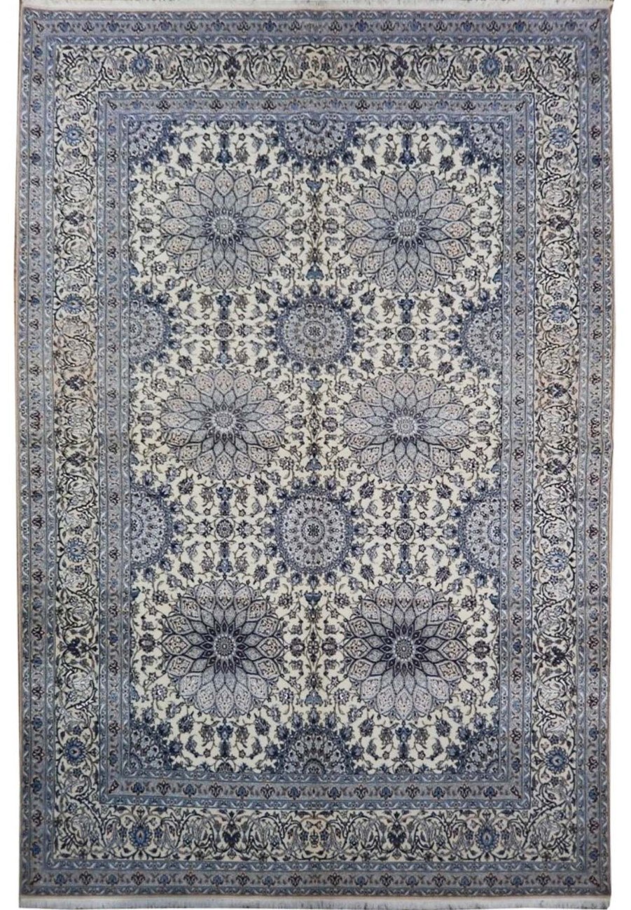 Full view of the 7 x 11 Persian Nain Habibian wool and silk 6 LAA rug signed by chief weaver showing ivory field with deep indigo blue medallion arabesque pattern and classical Habibian border