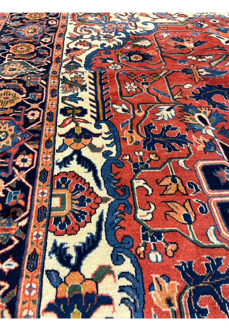 Pattern detail of a geometric Persian Heriz rug highlighting bold shapes, floral elements, and classic tribal structure