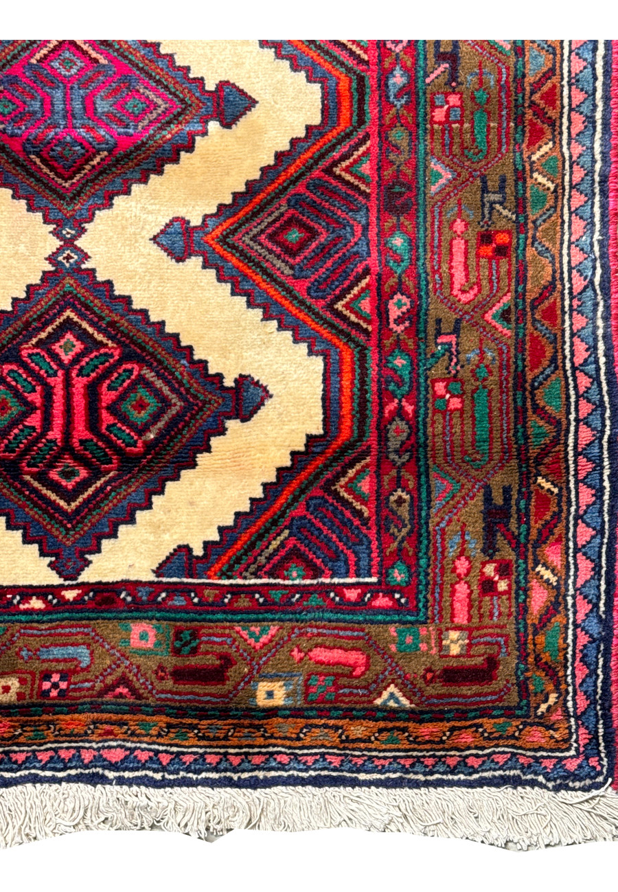 Corner detail of a Persian Hamedan runner rug displaying the fine weave and color contrast