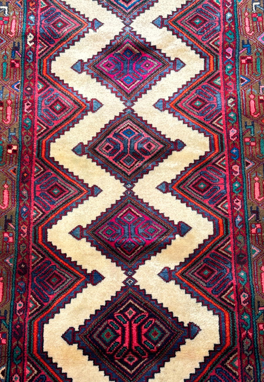 Detailed view of the central pattern and border of a handwoven Persian Hamedan runner rug