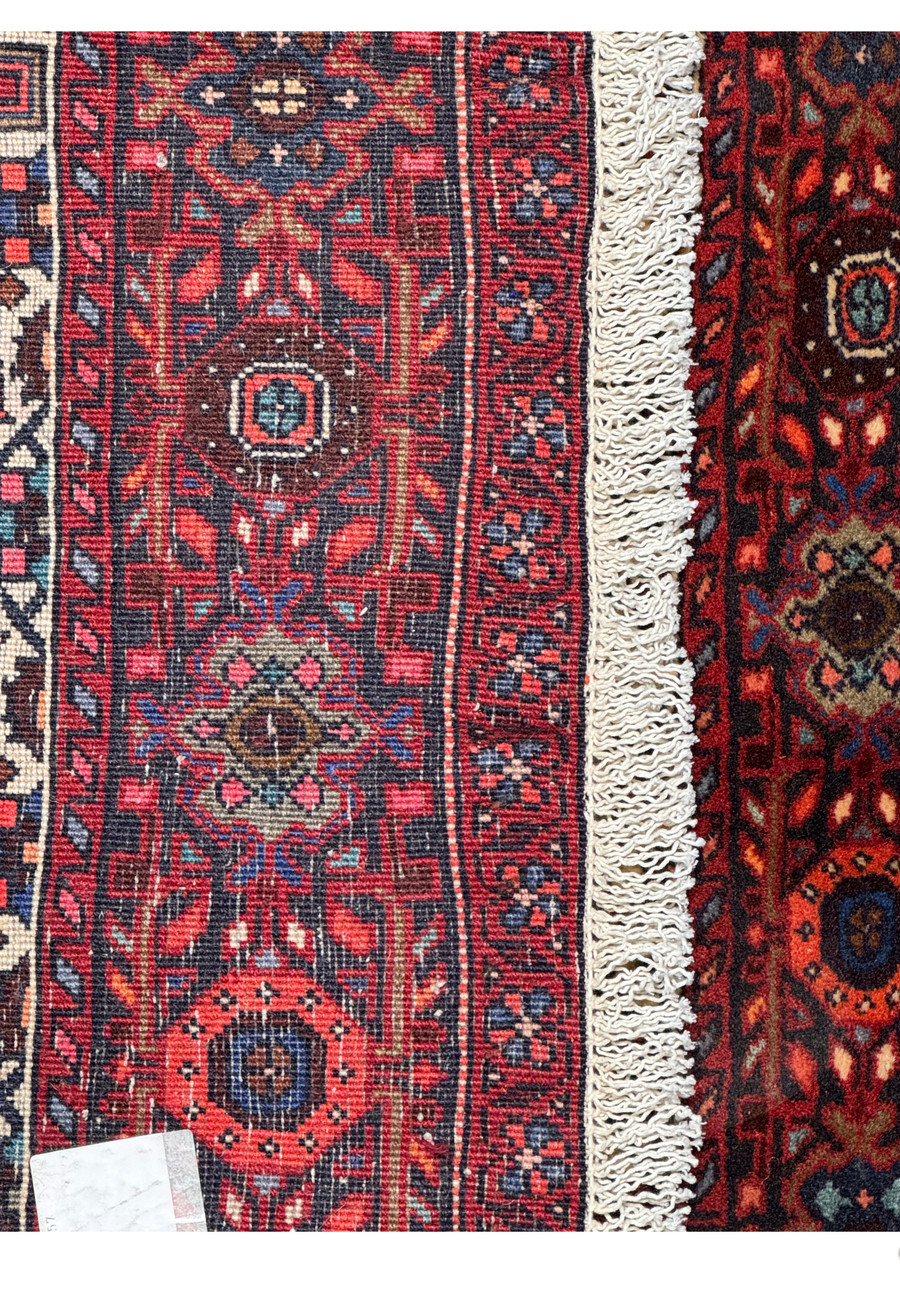 Label detail on Persian Gholtogh rug indicating size, origin, and material composition