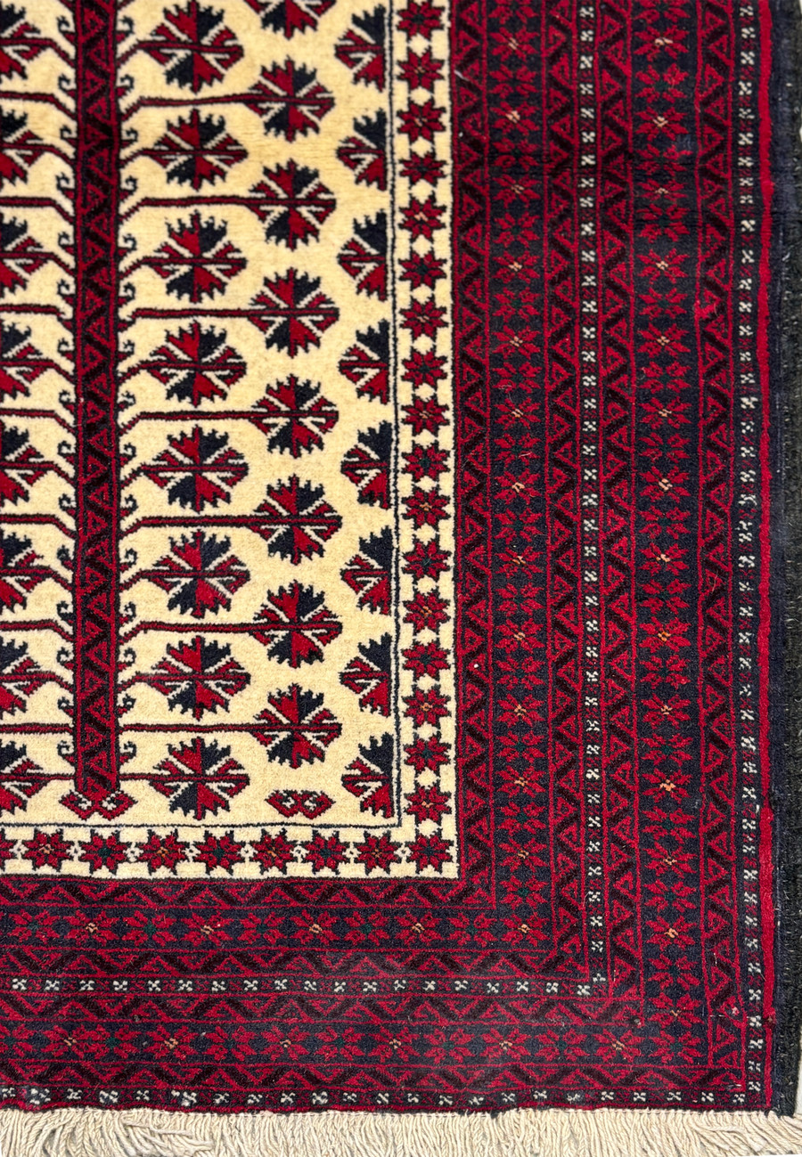Close-up of the prayer rug's border patterns, showcasing the traditional Baluch tribal designs